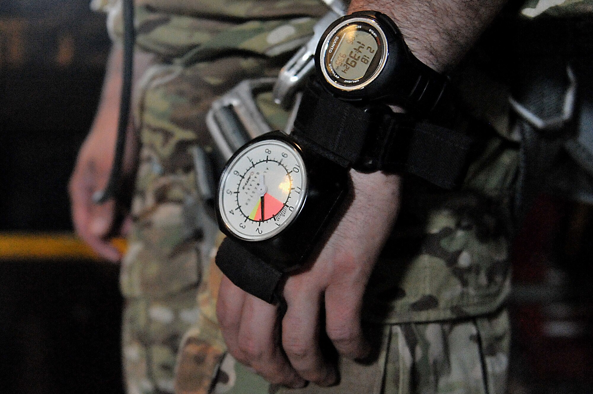 A U.S. Army paratrooper wears an altimeter before jumping from a C-130 Hercules during joint jump training at Yokota Air Base, Japan, Aug. 21, 2013.  The joint training was a unique experience for both Army and Air Force members, providing necessary training for jumpers to advance to senior jumpmaster status.  (U.S. Air Force photo by Airman 1st Class Soo C. Kim)
