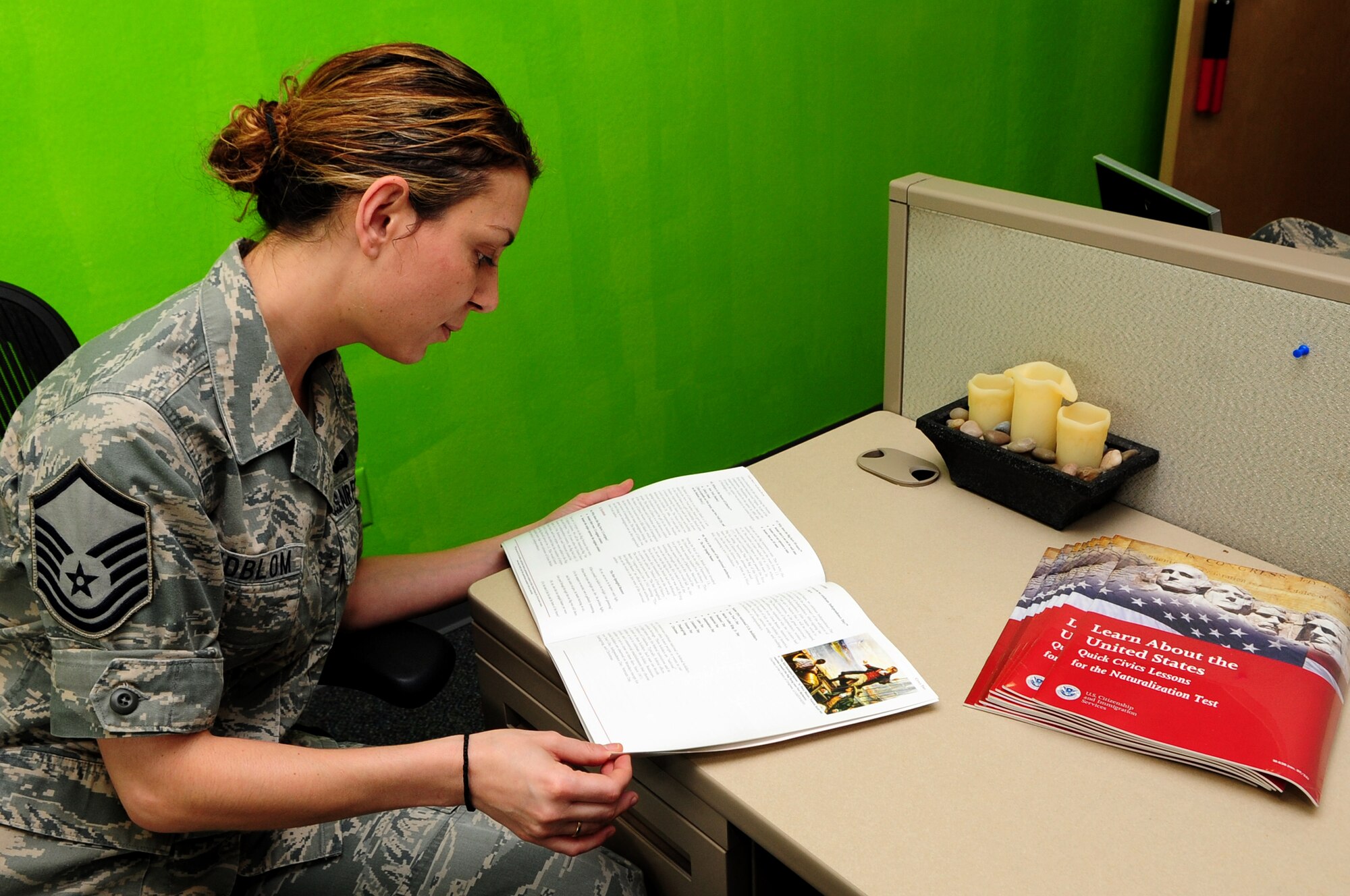 U.S. Air Force Master Sgt. Natasha Lindblom, 355th Comptroller Squadron Financial Management Flight chief, looks over the citizenship study material at Davis-Monthan Air Force Base, Ariz., Aug. 22, 2013. Lindblom has volunteered to assist Airmen and their spouses with preparation for the citizenship test . (U.S. Air Force photo by senior Airman Camilla Elizeu/released)