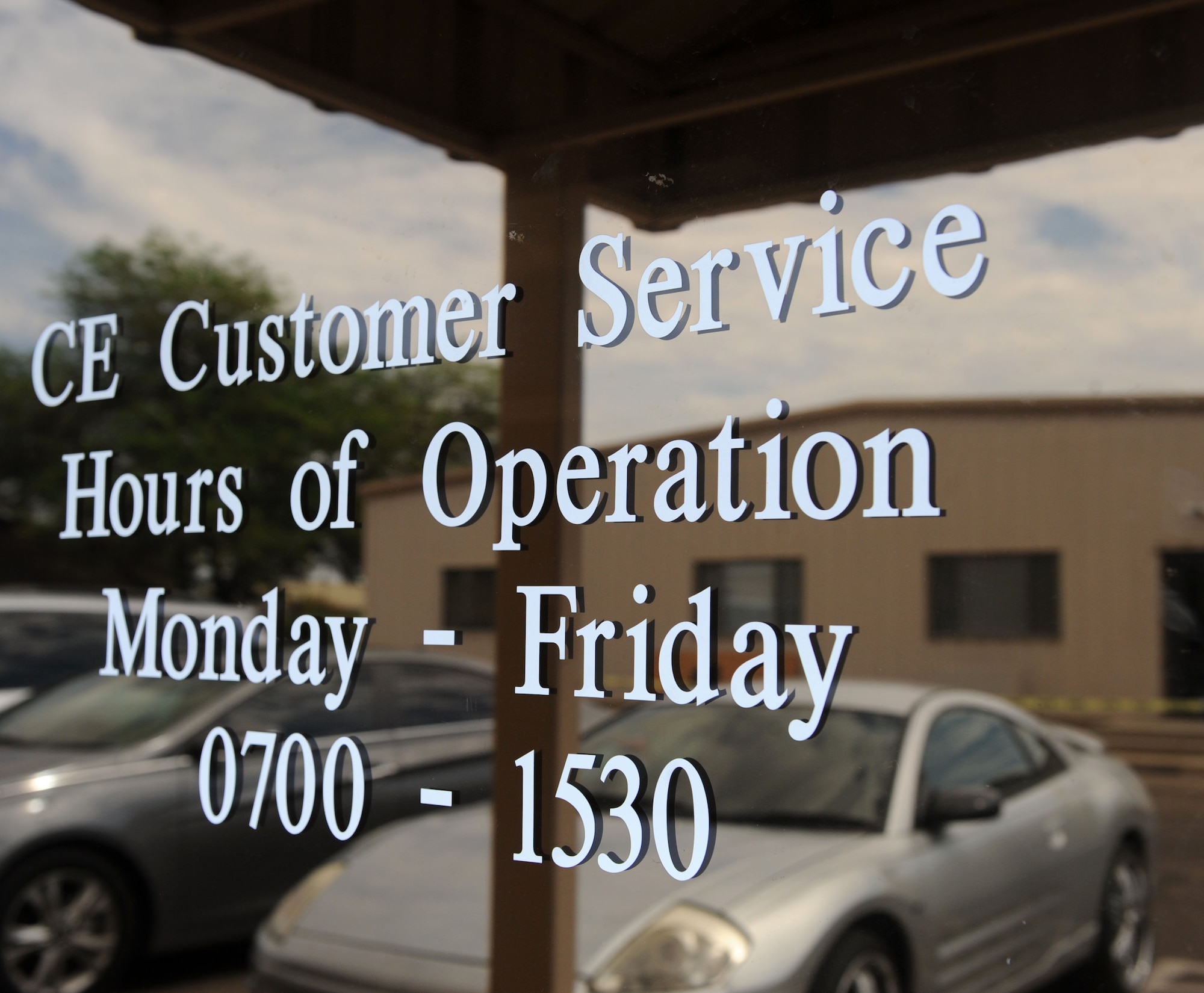 The business hours for the 355th Civil Engineer Squadron customer service section are displayed on its front door at Davis-Monthan Air Force Base, Ariz., Aug. 20, 2013. The customer service section takes phone calls and work orders for maintenance jobs around the base. (U.S. Air Force photo by Airman 1st Class Saphfire Cook/Released)