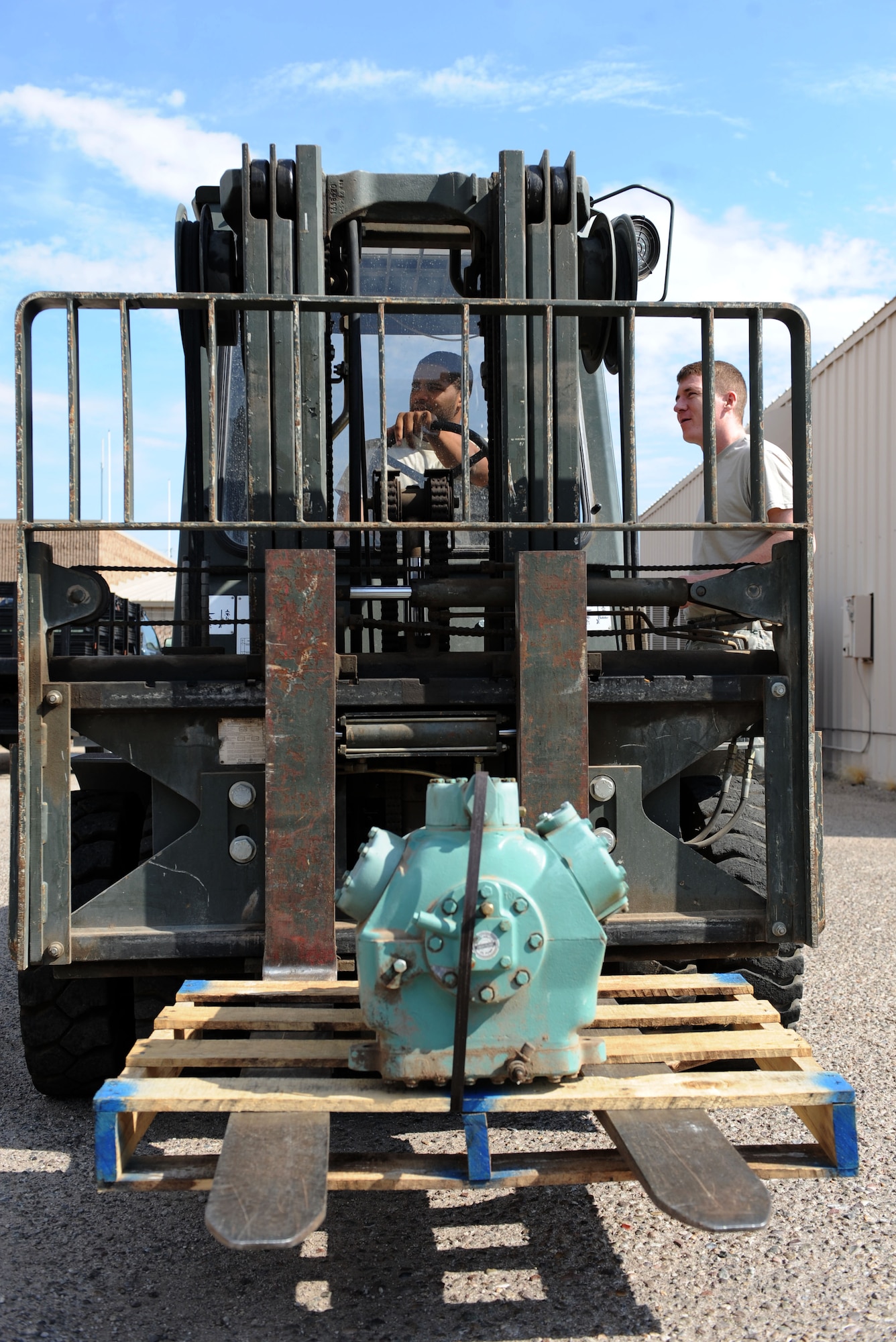 U.S. Air Force Airman 1st Class Andres Thomas, 355th Civil Engineer Squadron operations management, sits on a forklift at Davis-Monthan Air Force Base, Ariz., Aug. 20, 2013. The 355th CES is responsible for many of the behind-the-scenes base functions including maintenance of all facilities, properly functioning utilities, unaccompanied housing and environmental management. (U.S. Air Force photo by Airman 1st Class Saphfire Cook/Released)
