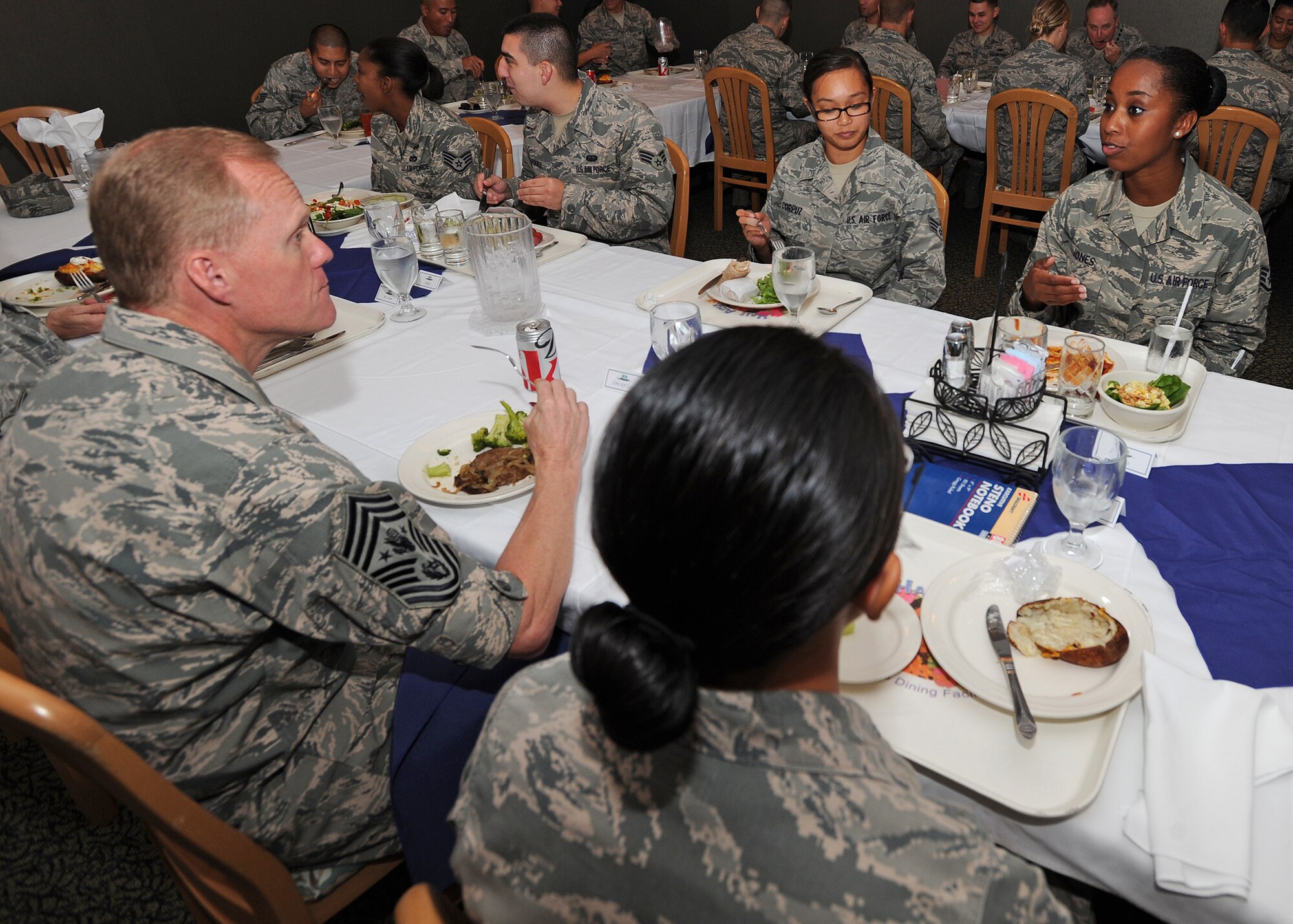 Chief Master Sgt. of the Air Force James Cody, shares lunch with Pacific Air Forces Airmen at the Hale Aina Dining Facility, Joint Base Pearl Harbor-Hickam, Hawaii, Aug. 19, 2013. Cody serves as the personal adviser to the Chief of Staff and the Secretary of the Air Force on all issues regarding the welfare, readiness, morale, and proper utilization and progress of the enlisted force. (U.S. Air Force photo/Tech. Sgt. Jerome S. Tayborn)