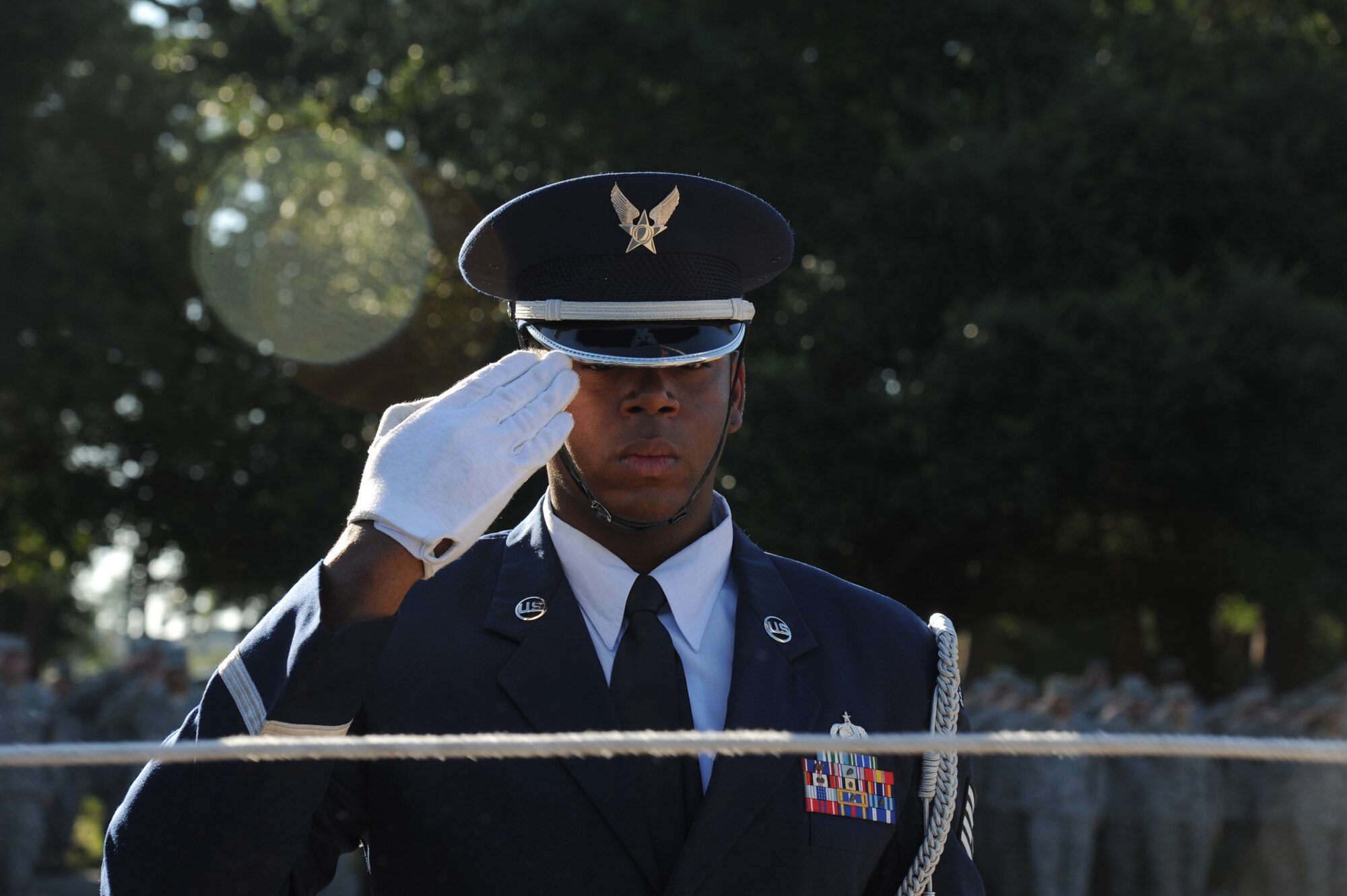 Staff Sgt. Vernon Peoples, Keesler Honor Guard, renders a salute as the American flag and the Commander-in-Chief’s Installation Excellence award flag are raised in front of the 81st Training Wing headquarters building Aug. 22, 2013, at Keesler Air Force Base, Miss.  Keesler was presented the award in April, 2013. (U.S. Air Force photo by Kemberly Groue)