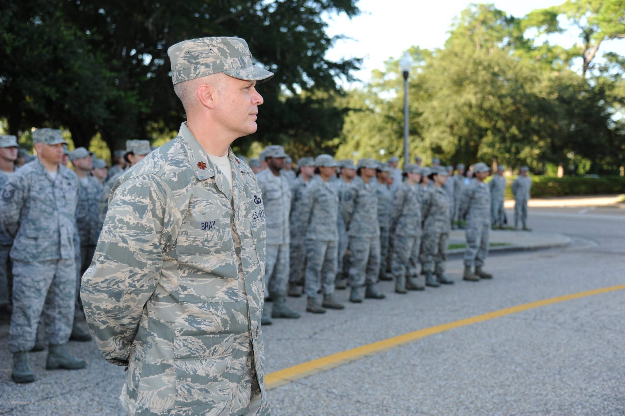 Maj. Kevin Bray, 334th Training Squadron commander, stands in front of his troops during a Commander-in-Chief’s Installation Excellence award flag raising ceremony in front of the 81st Training Wing headquarters building Aug. 22, 2013, at Keesler Air Force Base, Miss.  Keesler was presented the award in April, 2013. (U.S. Air Force photo by Kemberly Groue)