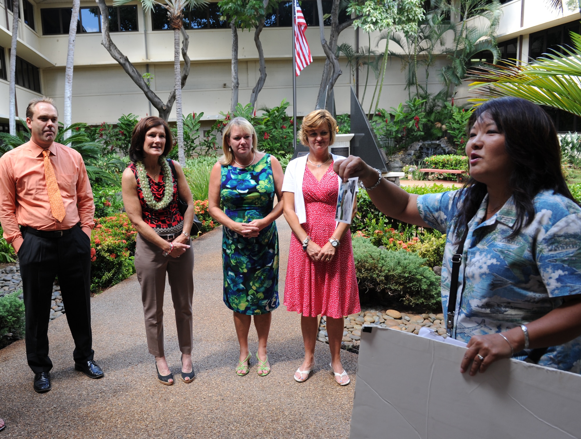 Jessie Higa, volunteer 15th Wing historian, provides a tour to Air Force spouses at the Courtyard of Heroes, Pacific Air Forces Headquarters, Joint Base Pearl Harbor-Hickam, Hawaii, Aug. 19, 2013. Attending the tour is Mrs. Athena Cody, left, wife of Chief Master Sgt. of the Air Force James A. Cody, Eric Hodeen, husband of Col. Julie Boit, Pacific Air Forces director of manpower, personnel and services, Betty Welsh, wife of Air Force Chief of Staff Gen. Mark A. Welsh III, MaryJoe McGillicuddy, wife of Brig. Gen. Paul McGillicuddy, PACAF chief of  staff, and Angie Basham, wife of Brig. Gen. Steven Basham, PACAF director of strategy, plans and programs. Gen. Welsh and Chief Cody’s visit JBPH-Hickam was the first leg of a visit to Air Force bases across the Pacific theater. Mrs. Welsh and Mrs. Cody met with family members and spouses to discuss opportunities and challenges regarding family care in the Pacific region. (U.S. Air Force photo/Master Sgt. Matthew McGovern)
