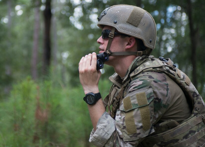 U.S. Air Force Senior Airman Rockwood Bullard, 23d Civil Engineer Squadron explosive ordnance disposal journeyman, scans for obstructions further down the trail during a wartime dismounted improvised explosive device operation exercise at Moody Air Force Base, Ga., Aug.20, 2013. Rockwood was part of a team utilizing a bomb disposal robot to place a charge on a suspected IED. (U.S. Air Force photo/Airman 1st Class Ryan Callaghan/Released)