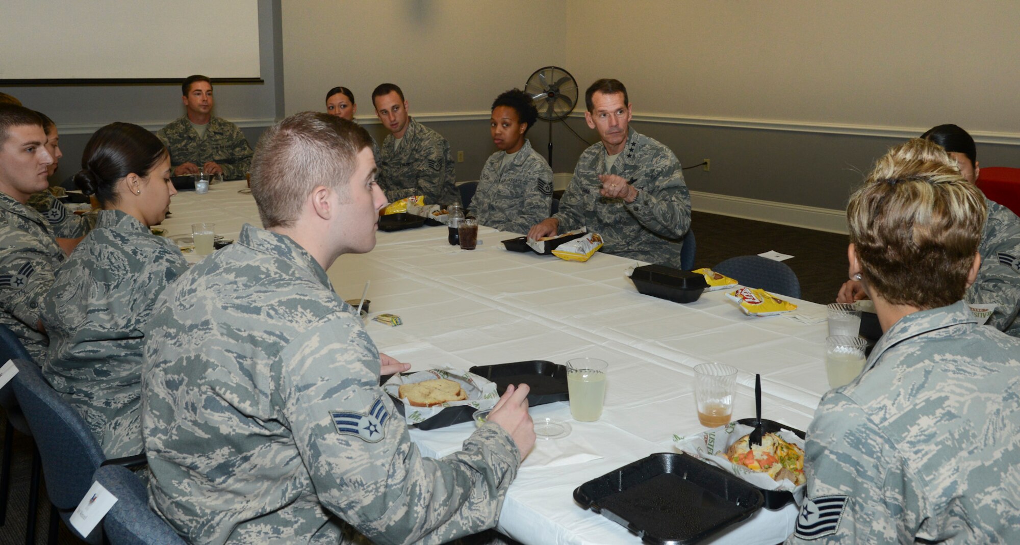 Lt. Gen. Stanley Clarke, director, Air National Guard eats lunch with the Airmen of the 136th Airlift Wing, Texas Air National Guard while listening to the Airmen’s concerns during his site visit at Naval Air Station Fort Worth Joint Reserve Base, Aug. 21, 2013. Lt. Gen. Clarke gave the Airmen a challenge to mentor others and serve with distinction. (Air National Guard photo by Senior Master Sgt. Elizabeth Gilbert/released)