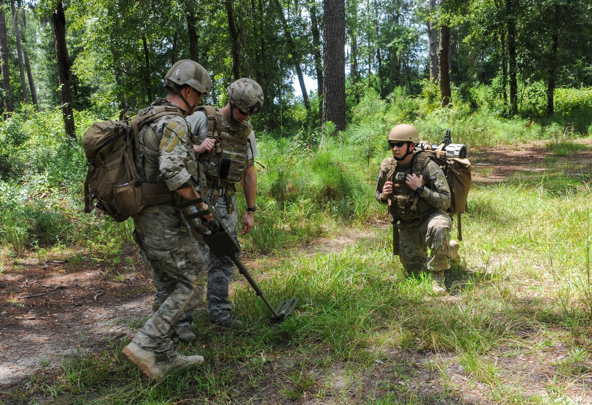 U.S. Air Force 1st Lt. Steven Bernero, right, 23d Civil Engineer Squadron explosives ordinance disposal (EOD) flight commander, and Staff Sgt. Daniel Esselstrom, middle, 23d Civil Engineer Squadron explosive ordinance disposal journeyman, watch as Senior Airman Rockwood Bullard, left, 23d Civil Engineer Squadron explosive ordinance disposal journeyman, scans the ground for metal wires at Moody Air Force Base, Ga., Aug 20, 2013. Bullard was leading a training exercise to help keep EOD members proficient. (U.S. Air Force photo by Airman Alexis Grotz/Released)