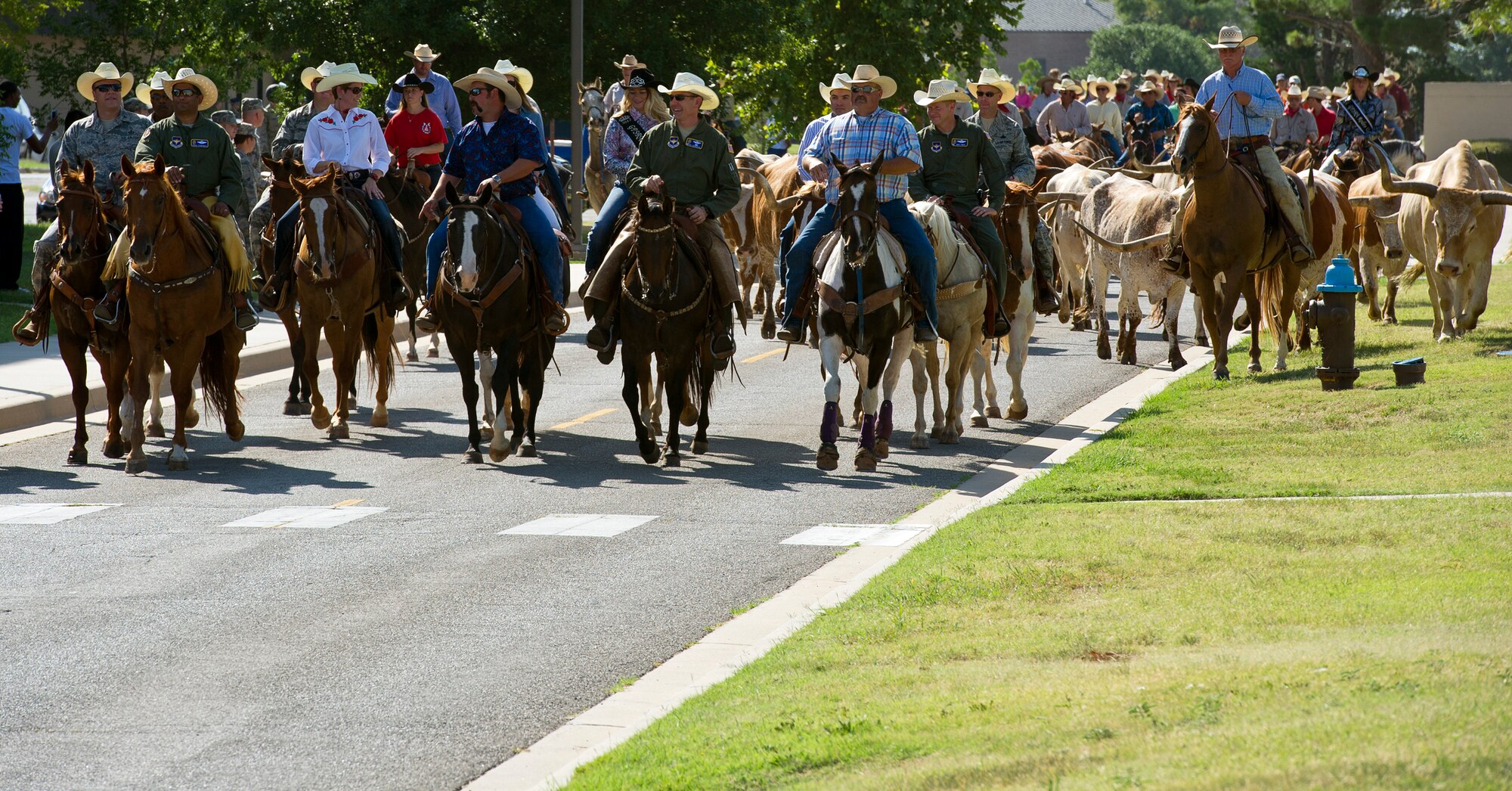 ALTUS AIR FORCE BASE, Okla. -- Base leadership and local community members lead a herd of cattle during the annual Cattle Drive on base, Aug. 22. The Cattle Drive has been at tradition at Altus AFB since Aug. 26, 1999. During the Cattle Drive, base and local community members herd cattle throughout the base to kick off the city’s Annual Great Plains Stampede Rodeo. (U.S. Air Force photo by Senior Airman Kenneth W. Norman / Released)