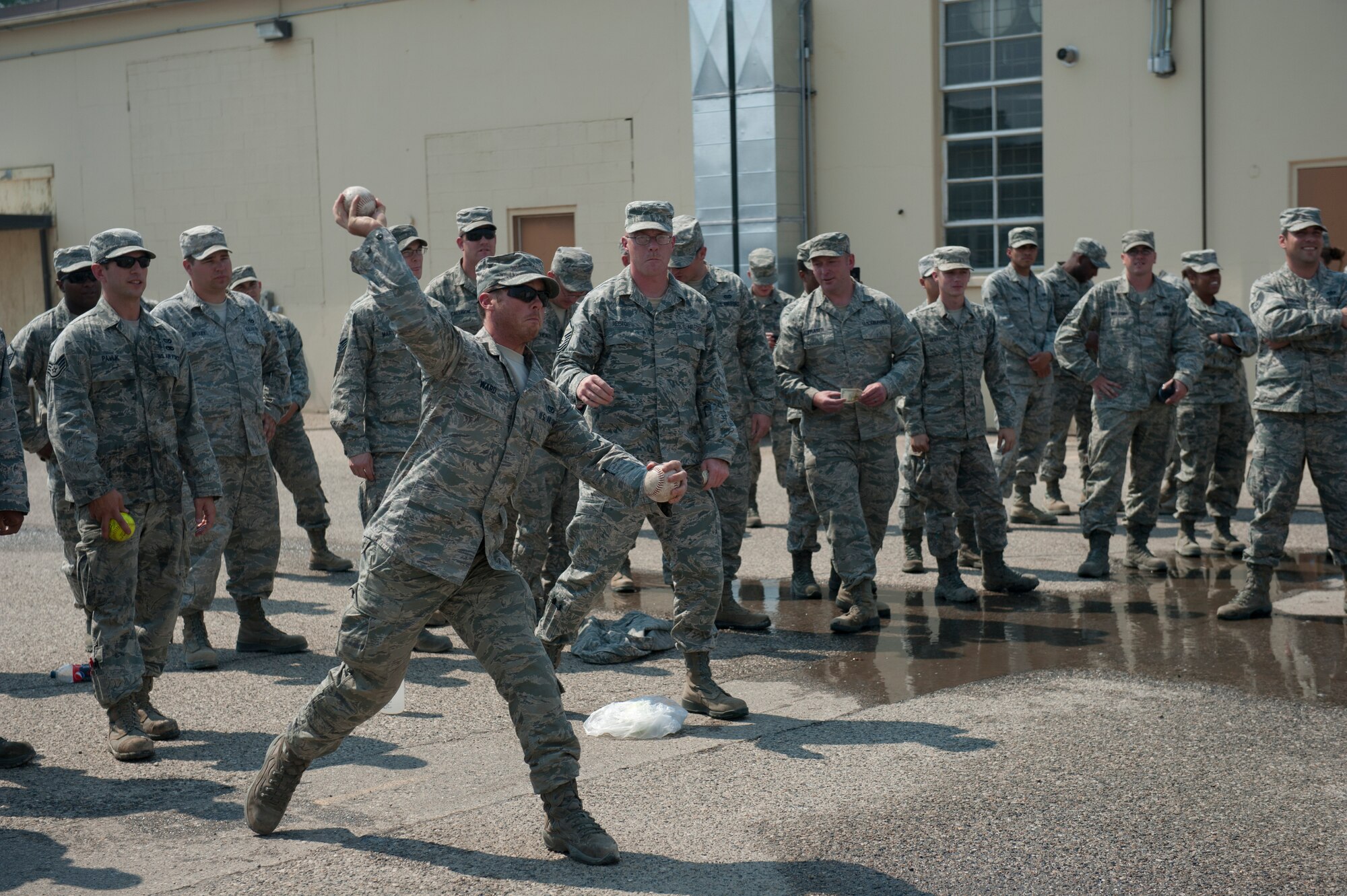 U.S. Air Force Senior Airman Joseph Ward, 366th Civil Engineering Squadron electrical systems journeyman, throws a softball at a dunk tank Aug. 15, 2013, at Mountain Home Air Force Base, Idaho. The two teams that lost the engineers’ challenge had to sacrifice themselves to the dunk tank. (U.S. Air Force photo by Airman 1st Class Brittany A. Chase/released)