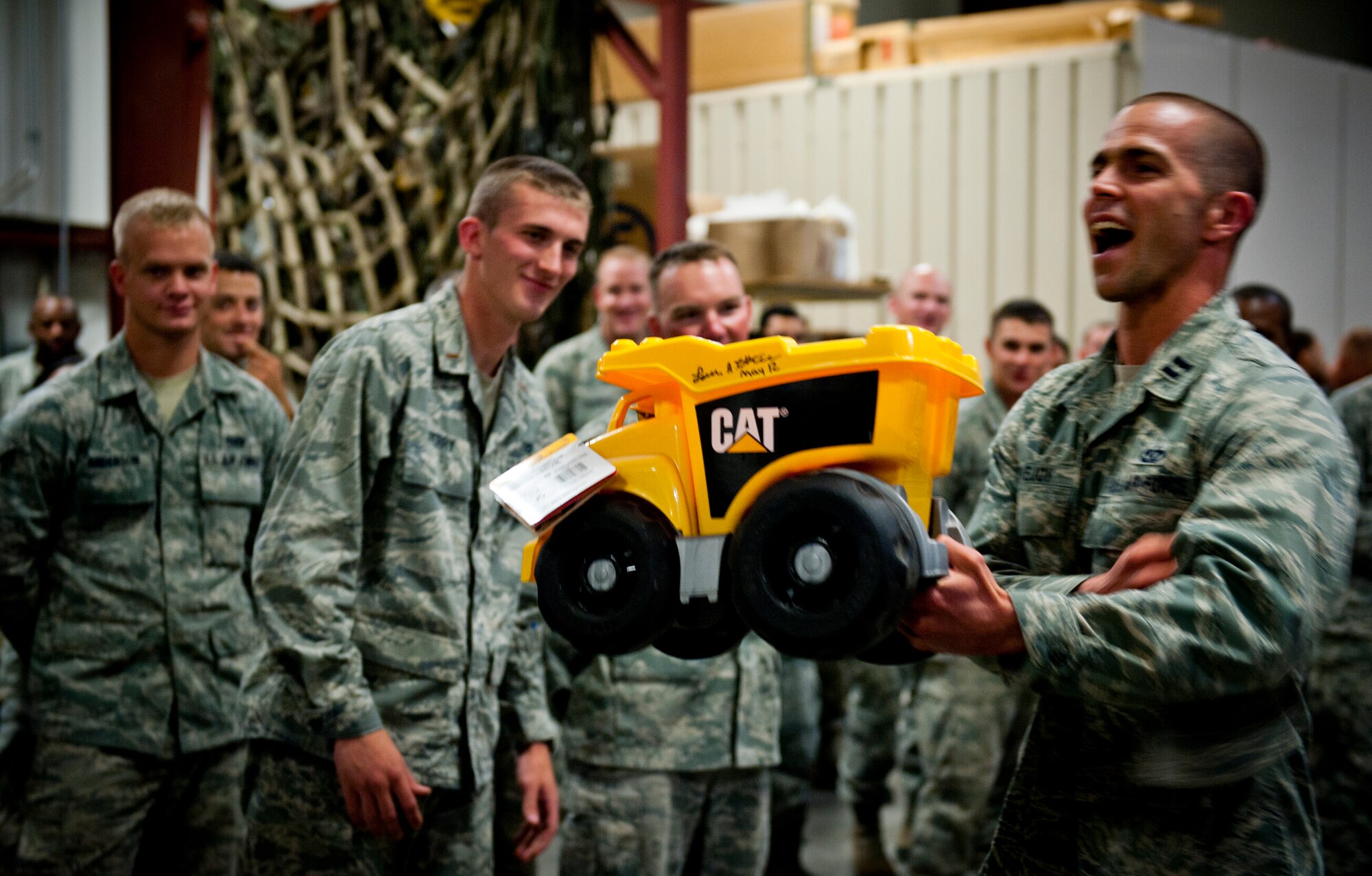 U.S. Air Force Capt. Austin Lovejoy, 366th Civil Engineering acting commander, presents the losing team lead with a trophy following an engineers’ challenge Aug. 15, 2013, at Mountain Home Air Force Base, Idaho. The losing team lead will carry and display the trophy until next year’s challenge. (U.S. Air Force photo by Airman 1st Class Brittany A. Chase/released)