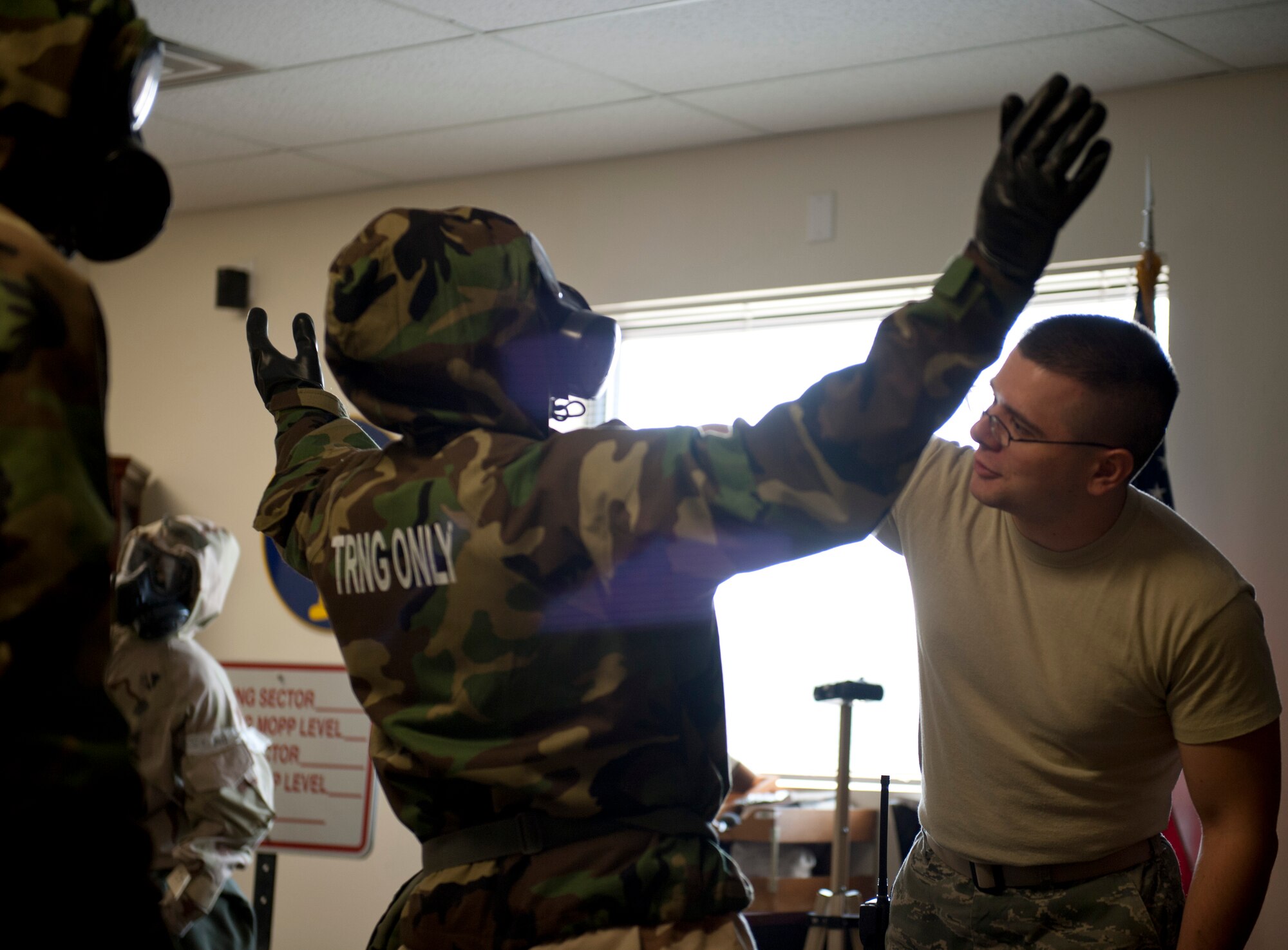 U.S. Air Force Senior Airman Robert Vroom, 366th Civil Engineering Squadron emergency management, inspects an Airman Aug. 15, 2013, at Mountain Home Air Force Base, Idaho. The groups competing had to assume mission-oriented protective posture four in the fastest time and the least discrepancies possible. (U.S. Air Force photo by Airman 1st Class Brittany A. Chase/released)