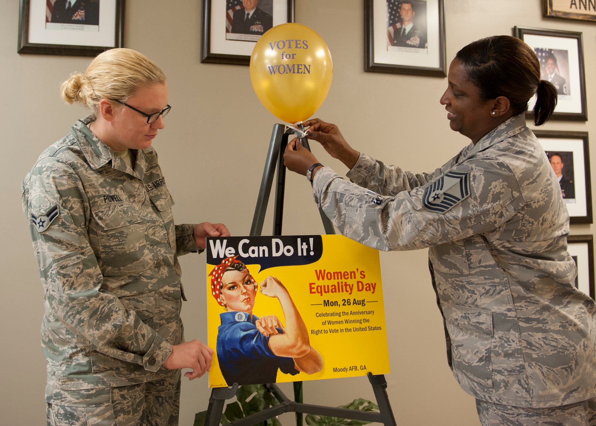 U.S. Air Force Airman 1st Class Emily Powell, 23d Force Support Squadron Military Personnel Services customer support representative, and Senior Master Sgt. Cheryl Moye, 23d FSS manpower and personnel flight chief, set up a display for the Women’s Equality Day in the Parker Greene Base Support Center at Moody Air Force Base, Ga., Aug. 19, 2013. Powell and Moye are the first at Moody to congregate a committee commemorating Women’s Equality Day which begins Aug. 26, the day women were officially allowed to vote in 1920. (U.S. Air Force photo by Senior Airman Eileen Meier/Released) 
