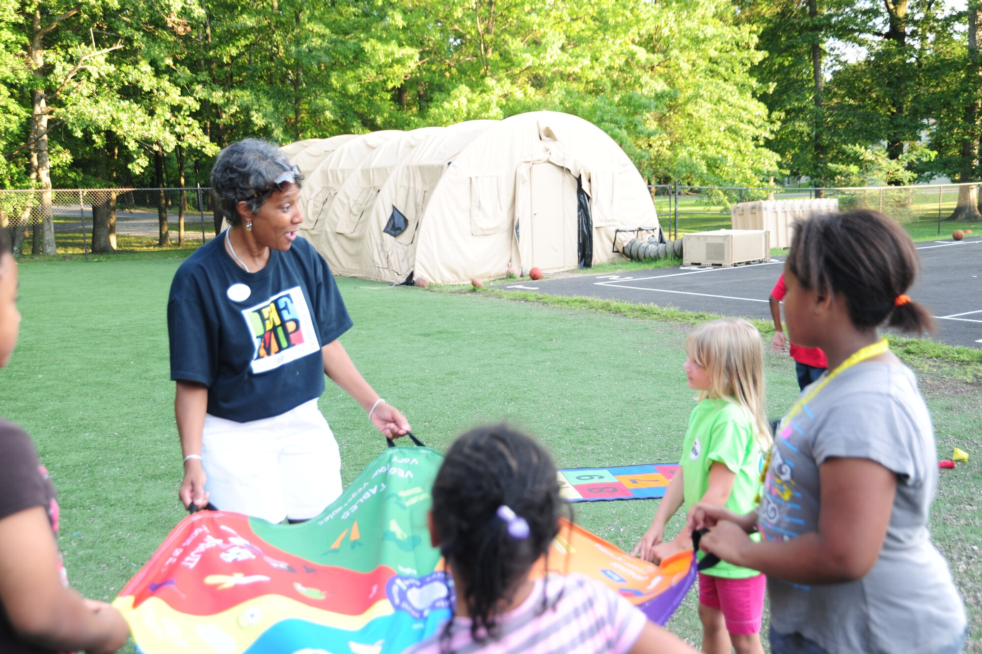 Adreinne Barnett, Exceptional Family Member Program, EFMP, coordinator, leads a fitness class that incorporated healthy eating lessons with a game, Aug. 15, 2013, at the Back-to-School Bash event held at the Youth Center on Joint Base Andrews, Md. When the bean bag landed on a food group the children took turns discussing their favorite types of food and appropriate portions. (U.S. Air Force photo/ Ms. Amber J. Russell)