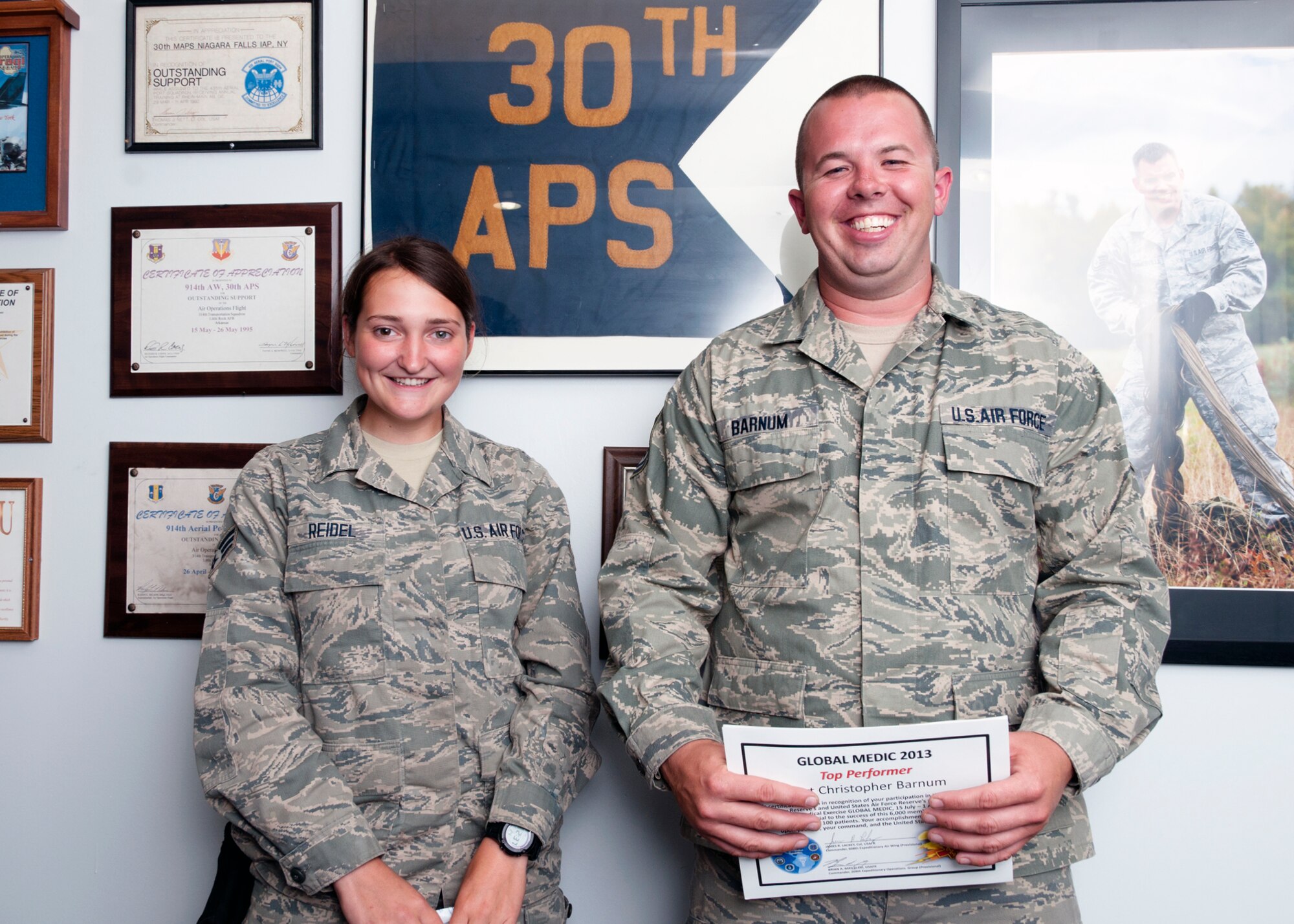 Tech. Sgt. Christopher Barnum and Senior Airman Michelle Reidel were acknowledged for their contributions for Warrior Exercise/Exercise Global Medic, Fort McCoy, Wis., July 12 through August 2. WAREX units an opportunity to rehearse military maneuvers and tactics. Held in conjunction with WAREX, Global Medic is an annual joint-field training exercise designed to replicate all aspects of theater combat medical support. (U.S. Air Force photo by Tech. Sgt. Joseph McKee)