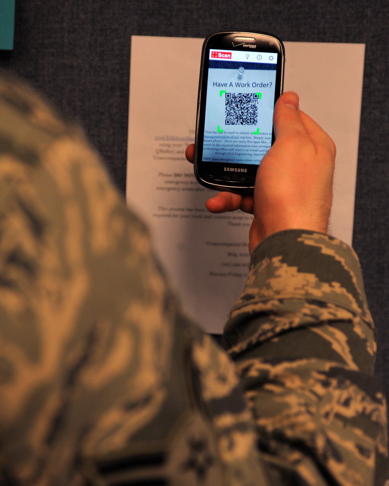 An Airman uses a free application to scan a quick response code at Davis-Monthan Air Force Base, Ariz., Aug. 22, 2013. The Unaccompanied Housing Office here has implemented a QR code system, which allows Airmen to immediately submit work orders about discrepancies around the dormitory campus. (U.S. Air Force photo by Senior Airman Timothy Moore/Released)