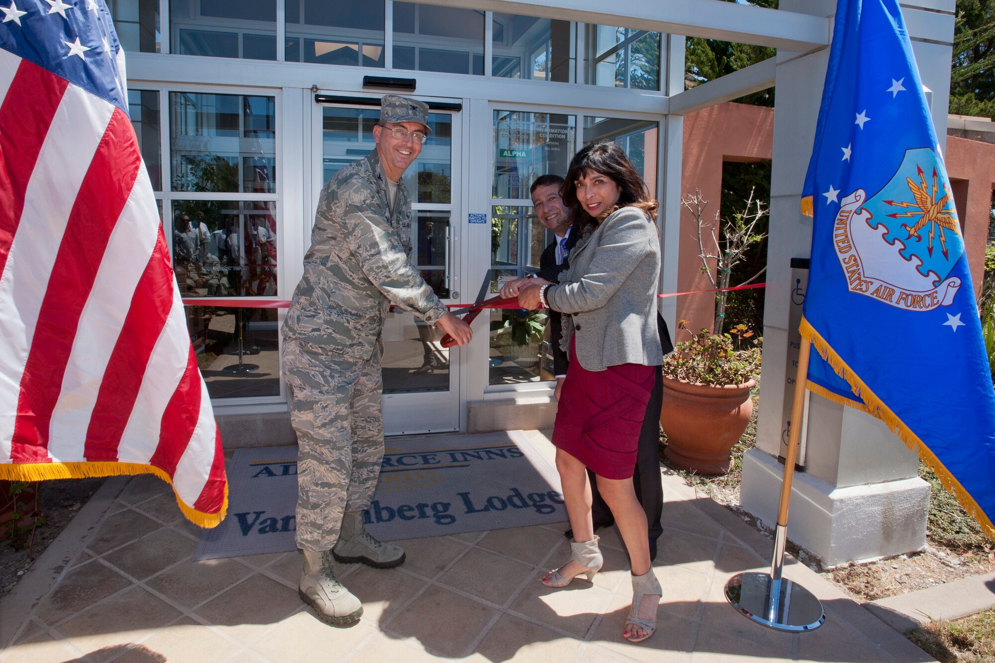 VANDENBERG AIR FORCE BASE, Calif. -- Col. Keith Balts, 30th Space Wing commander, Daniel Becker, Vandenberg Lodging general manager, and Elizabeth Waters, 30th Civil Engineer Squadron interior designer, cut a ribbon for the new lodging office here Tuesday, August 20, 2013. The new facility gives the Vandenberg Lodging center a bigger, brighter building and provides a better first impression for guests and customers. (U.S. Air Force photo/Airman Yvonne Morales)