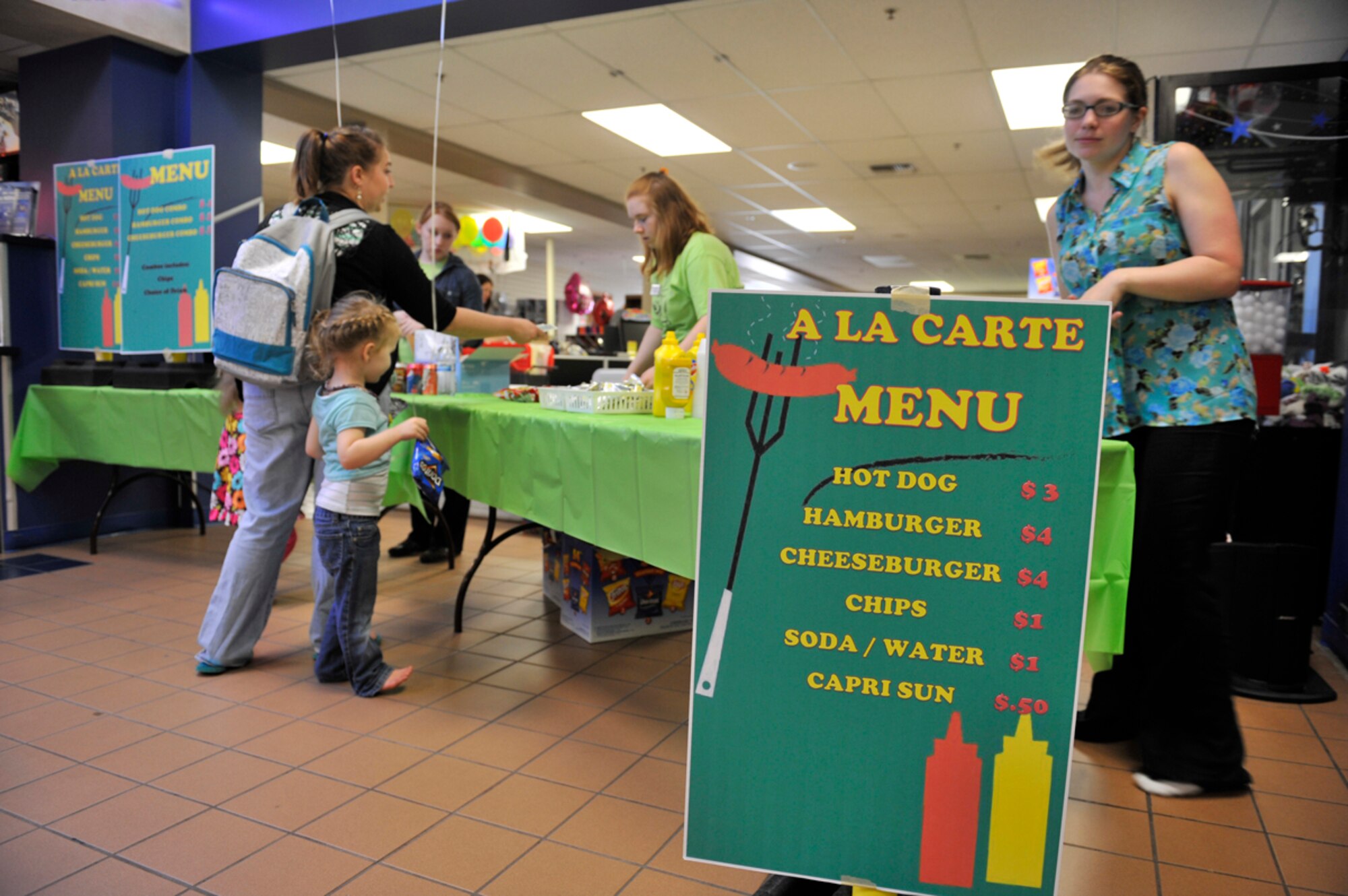 8/16/2013 - JOINT BASE ELMENDORF-RICHARDSON, Alaska--Volunteers from the Arctic Oasis Community Center provide hot dogs and hamburgers to hungry guests during the Back to School Bash on Joint Base Elmendorf-Richardson Aug. 16. The Back to School Bash was hosted to by the Arctic Oasis Community Center members to get children excited to go back to school. (U.S. Air Force photo/Airman 1st Class Tammie Ramsouer)