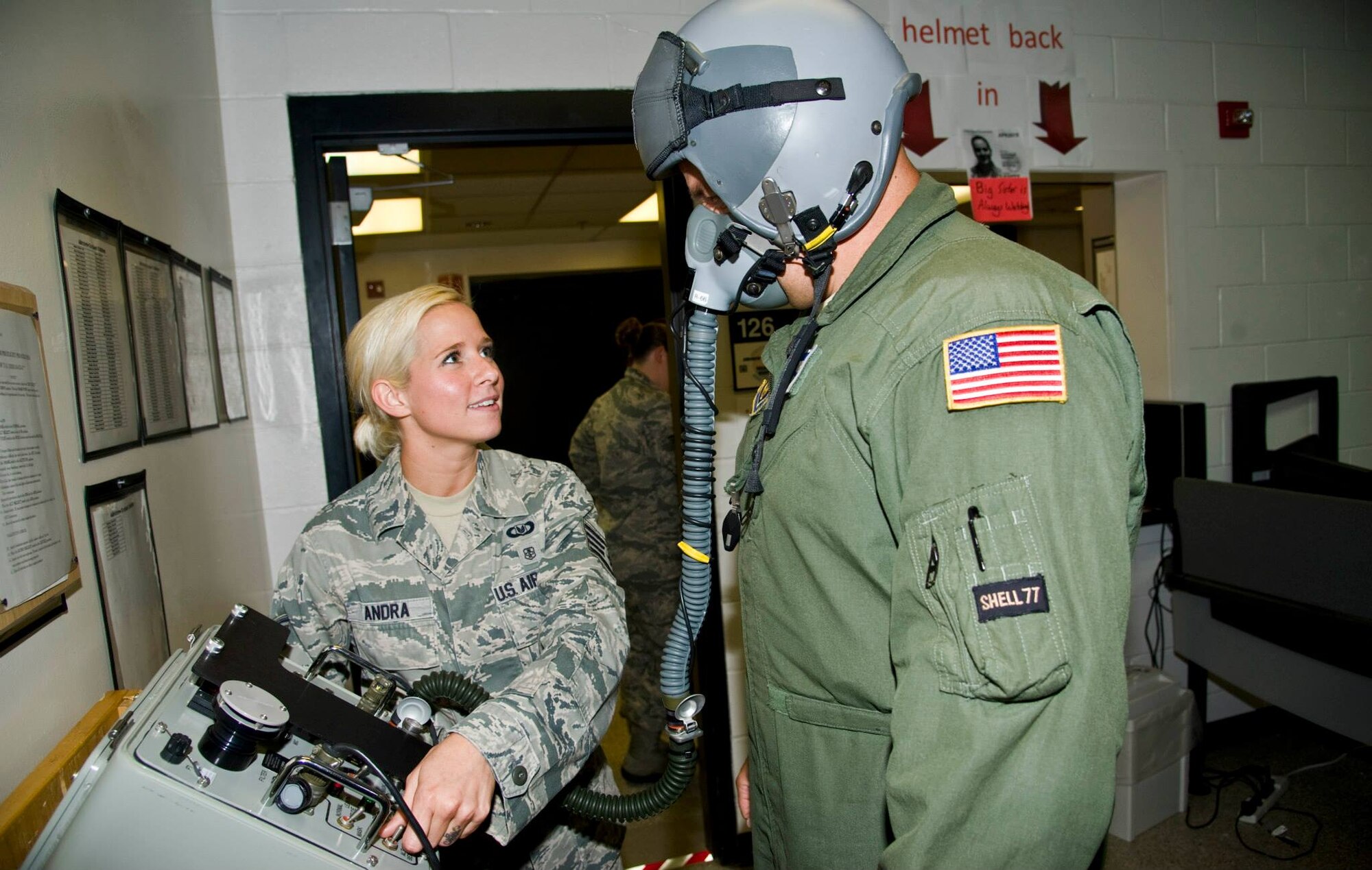 Staff Sgt. Leirin Andra, 931st Operation Support Squadron air crew flight equipment, assists Master Sgt. Warren Bearup, 931st OSS boom operator, with a helmet functionality check Aug. 21st, 2013, at McConnell Air Force Base Kan. AFE Airmen must make sure all equipment aircrews may use is in working condition and able to operate at varying altitudes. (U.S. Air Force photo/Airman 1st Class John Linzmeier)
