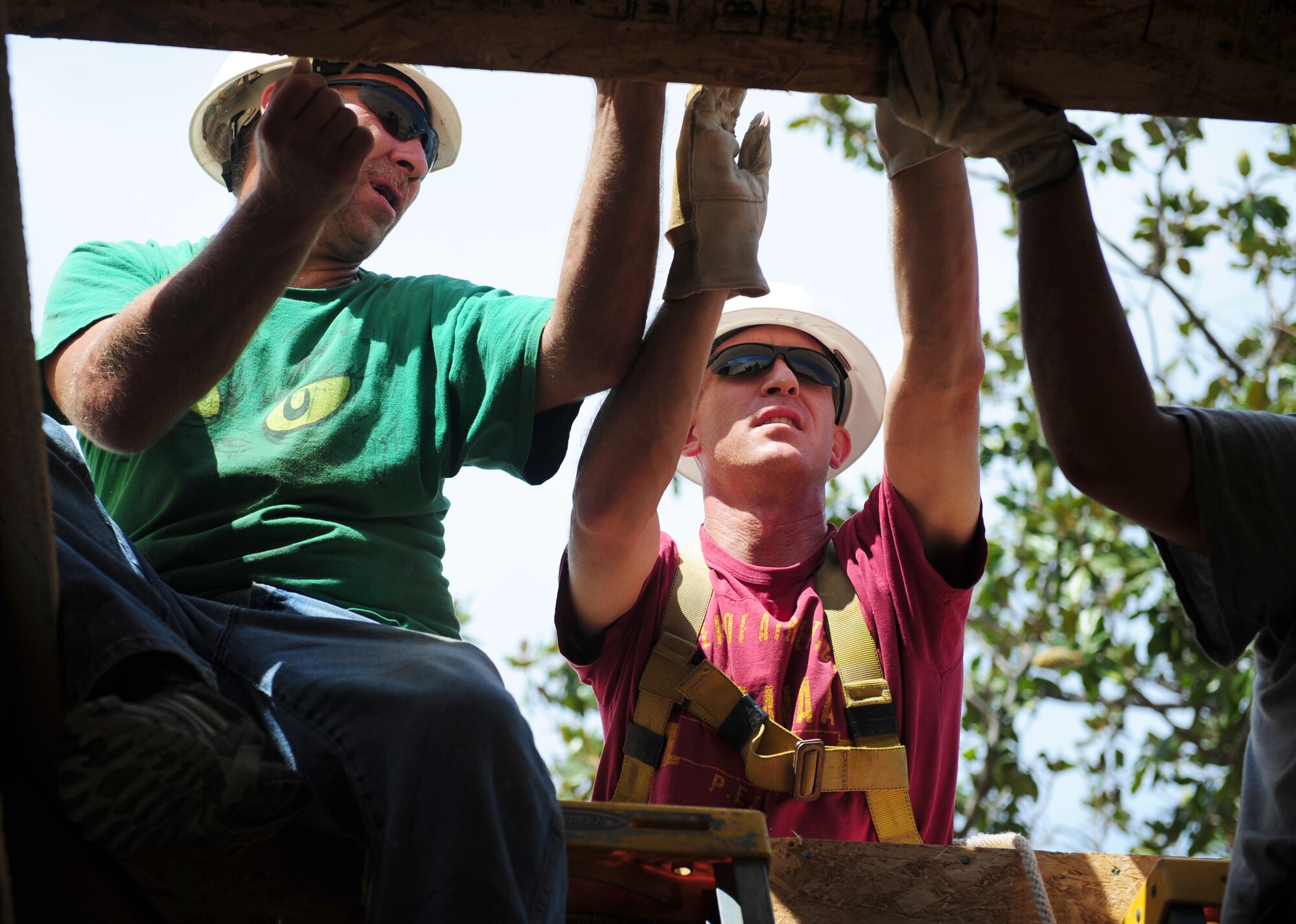 Lt. Col. David Dengler (center), 13th Intelligence Squadron commander, places roofing upon a home in Marysville, Calif., on Aug. 17, 2013. Denglar and other Beale service members teamed with Habitat for Humanity for the construction of the home. (U.S. Air Force photo by Airman 1st Class Bobby Cummings/Released)