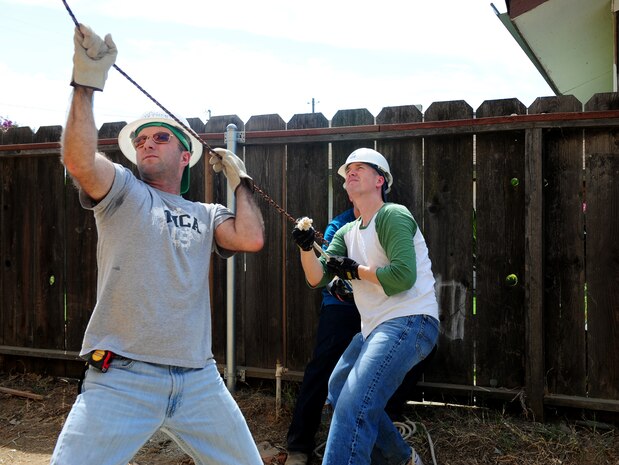 Lt. Col. Jason Arnold (right), Operations Support Squadron commander, and 1st Lt. Phil, man a rope at a home under construction in Marysville, Calif., on Aug. 17, 2013. Beale Airmen have been volunteering for Habitat for Humanity to aid in the homes completion. (U.S. Air Force photo by Airman 1st Class Bobby Cummings/Released)