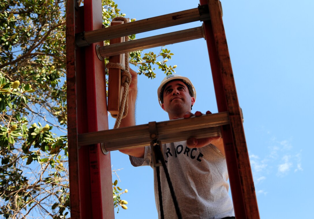 Capt. Jon, 13th Intelligence Squadron, climbs a ladder at a home under construction in Marysville, Calif., on Aug. 17, 2013. Beale Airmen have been volunteering for Habitat for Humanity to aid in the homes completion. (U.S. Air Force photo by Airman 1st Class Bobby Cummings/Released)
