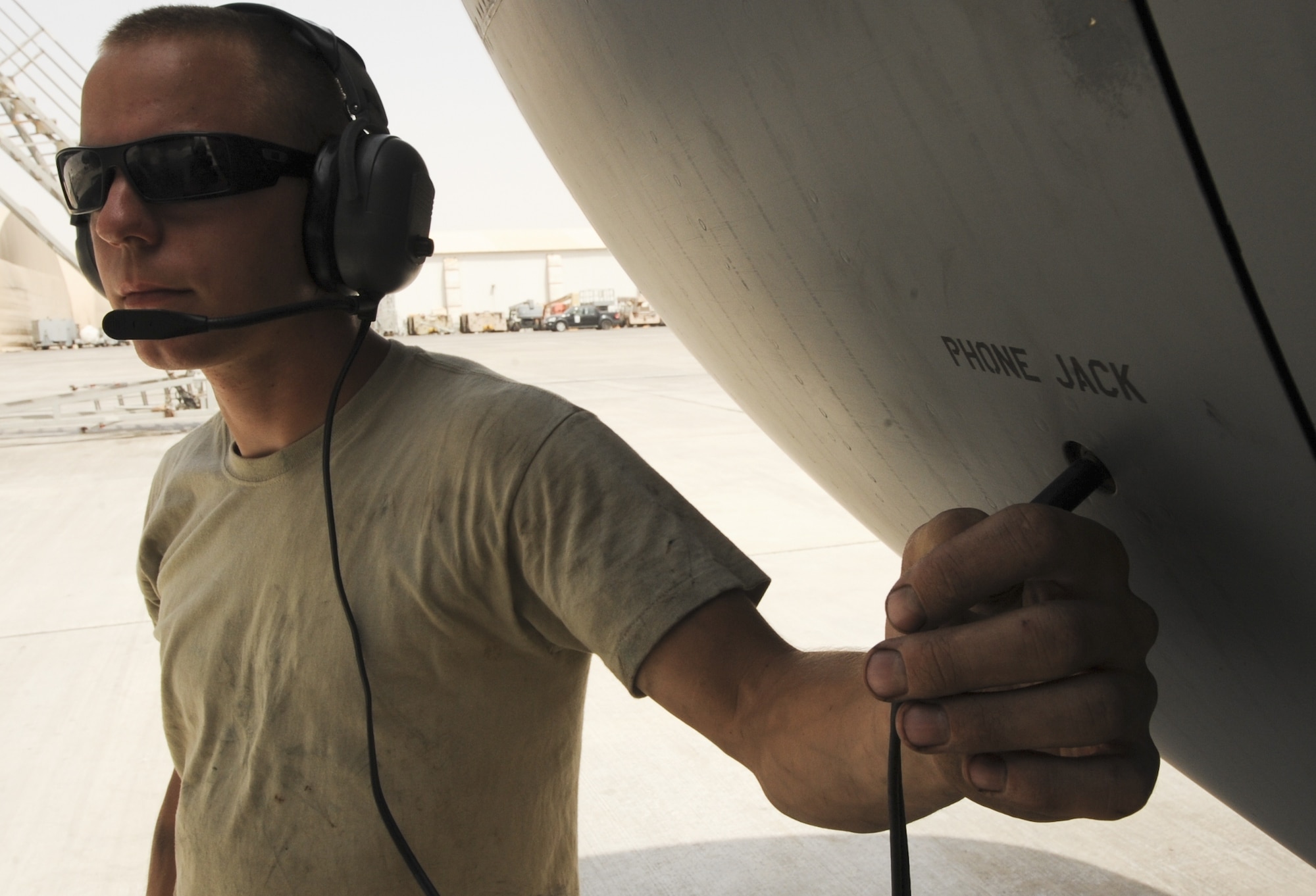 U.S. Air Force Airman 1st Class Ryan Bertsch, 380th Expeditionary Aircraft Maintenance Squadron KC-10 Aircraft Maintenance Unit aircraft hydraulic systems technician, listens to a crew chief from inside the aircraft while running a systems check on a KC-10 Extender at an undisclosed location in Southwest Asia Aug. 5, 2013. Bertsch calls Rochester, Minn., home and is deployed from Travis Air Force Base, Calif. (U.S. Air Force photo by Staff Sgt. Jacob Morgan/Released)