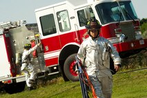 Firefighters assigned to the 5th Civil Engineer Squadron respond to an incident during a field training exercise at Minot Air Force Base, N.D., Aug. 20, 2013. The purpose of the exercise is to evaluate and validate the integration and response of emergency management, security forces, fire department, medical and missile field operations during a nuclear incident and natural disaster. (U.S. Air Force photo/Senior Airman Brittany Y. Auld)