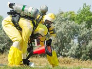 Explosive Ordnance Disposal technicians assigned to the 5th Civil Engineer Squadron, assess levels of radiation during a field training exercise at Tango-01, Aug. 20. The exercise was done to evaluate and validate the integration and response of Emergency Management, Security Forces, Fire Department, Medical and Missile Field Operations to an incident. (U.S. Air Force photo/Airman 1st Class Kristoffer Kaubisch)
