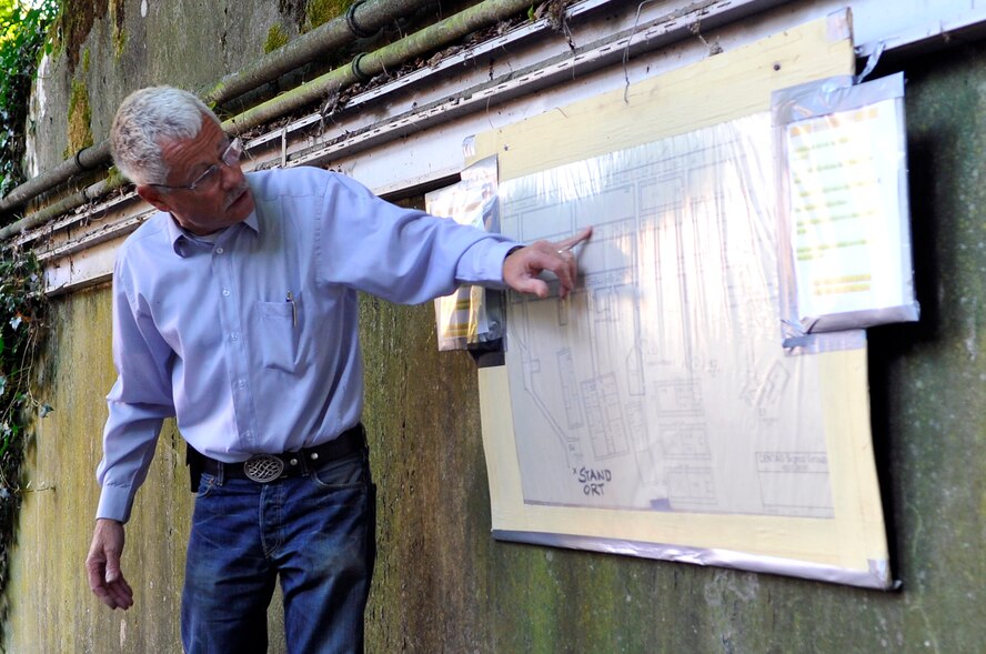 Wolfgang Wuermel, owner of the Kindsbach Cave, details a map of the Air Defense Operations Center bunker, Aug. 16, 2013, Kindsbach Cave, Germany. The bunker was built prior to World War II and was utilized for command and control operations for the German army. After the war, it was passed to the French, who used it primarily for storing munitions. The U.S. Air Force gained control of the bunker in 1954 and turned it back into a command and control center where air operations could have been led if the Cold War turned hot. (U.S. Air Force photo/Airman 1st Class Trevor Rhynes)