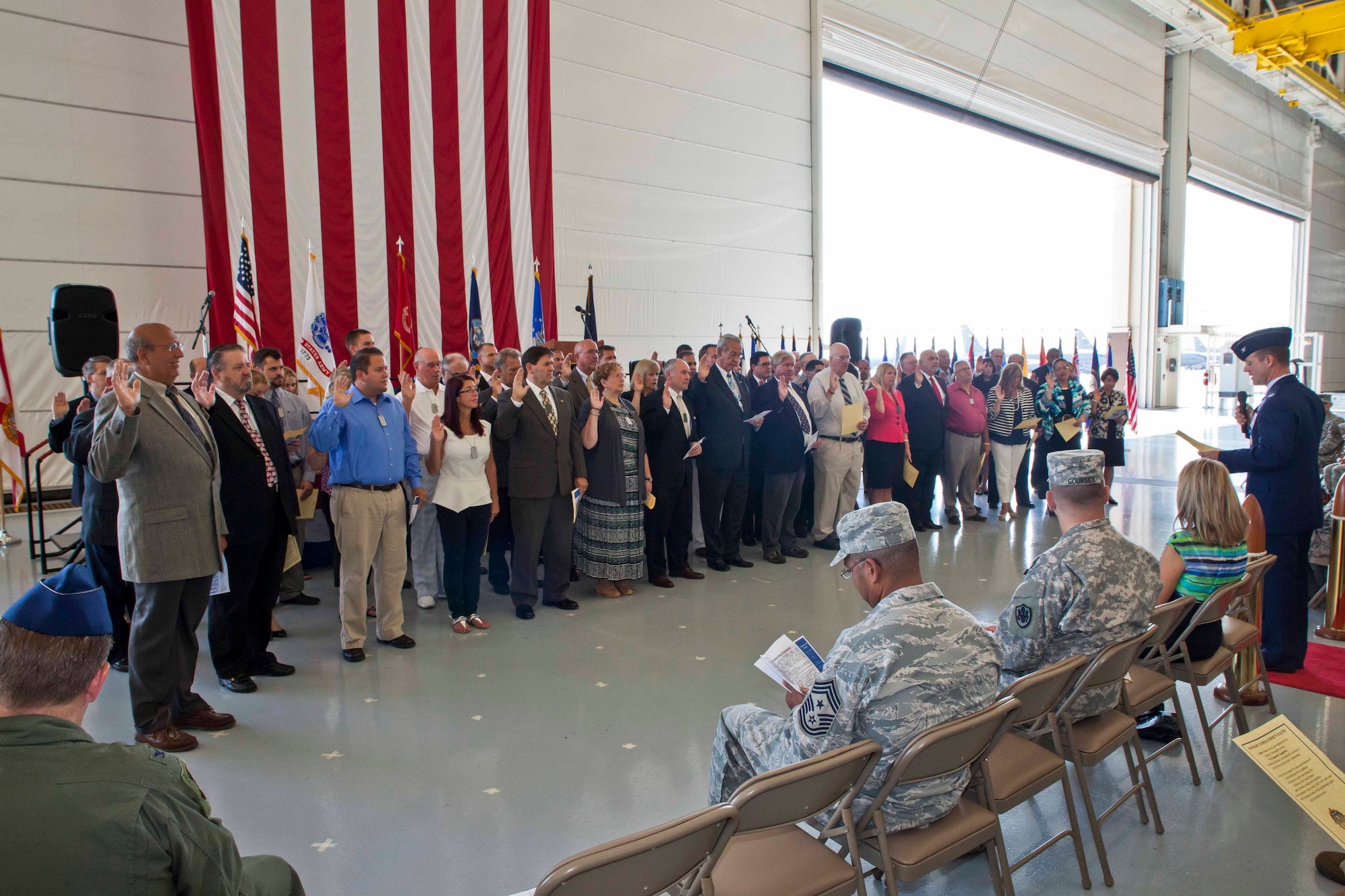 Col. James C. Hodges, Joint Base McGuire-Dix-Lakehurst commander, gives the Honorary Commander's Oath to key leaders of the surrounding communities for their active role as Honorary Commanders for various units throughout JB MDL during the Joint Base Honorary Commanders Induction ceremony Aug. 20, 2013 on JB MDL, N.J. The Honorary Commanders program provides commanders with a means to effectively educate participants on the Air Force, Army and Navy missions of JB MDL and encourages an exchange of ideas, experiences and friendships with members of the local community. Each honorary commander serves a one-year term and during this time they are invited to participate in various installation and unit events. (U.S. Air Force photo by Wayne Russell/Released)