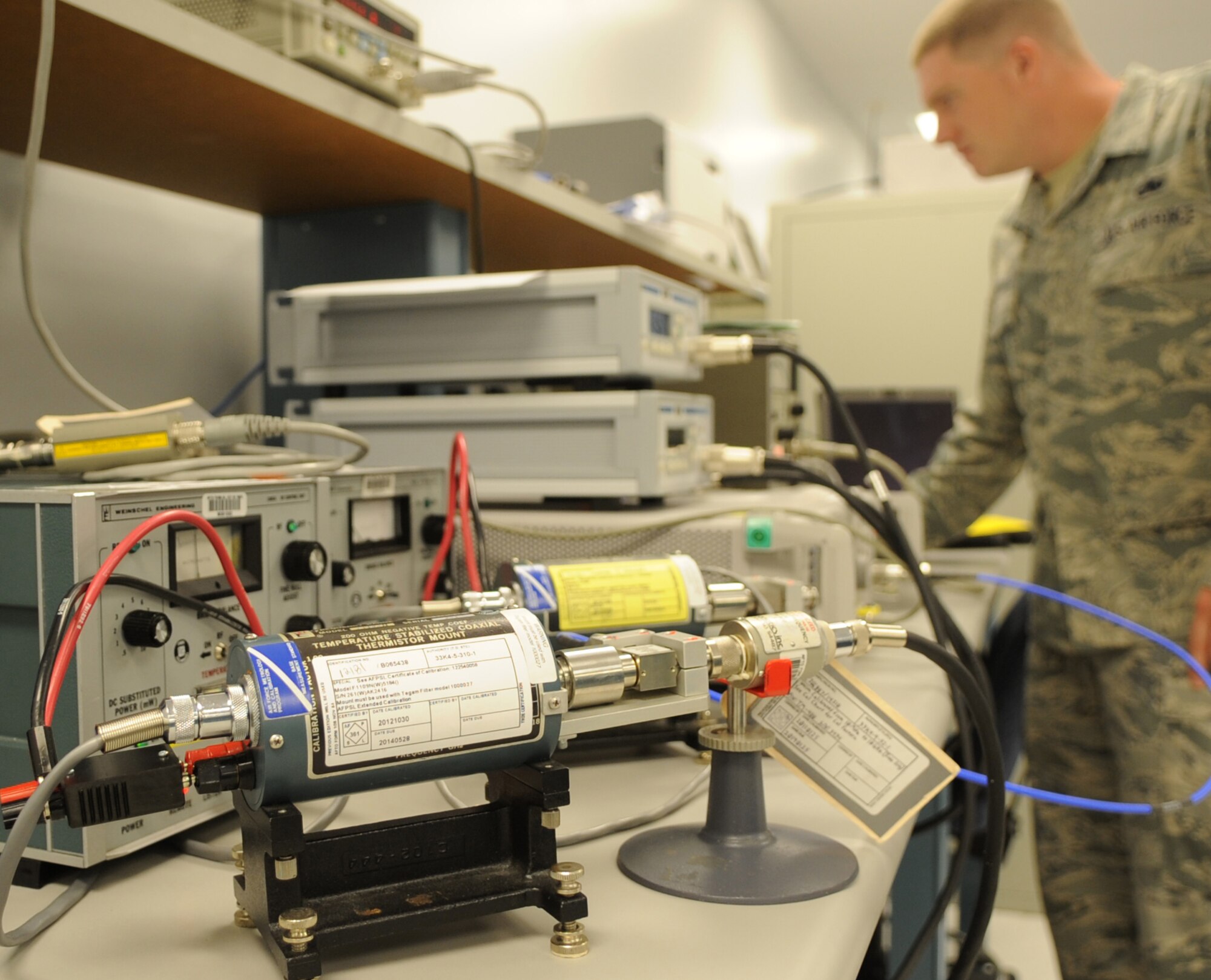 Staff Sgt. Joseph Hickman, a 19th Component Maintenance Squadron Precision Measurement Equipment Laboratory technician, calibrates a thermistor mount and power sensor for a radio frequency Aug. 8, 2013, at Little Rock Air Force Base, Ark. PMEL specializes in the calibration of many types of devices and equipment to help keep the base mission-ready. (U.S. Air Force photo by Staff Sgt. Caleb Pierce) 