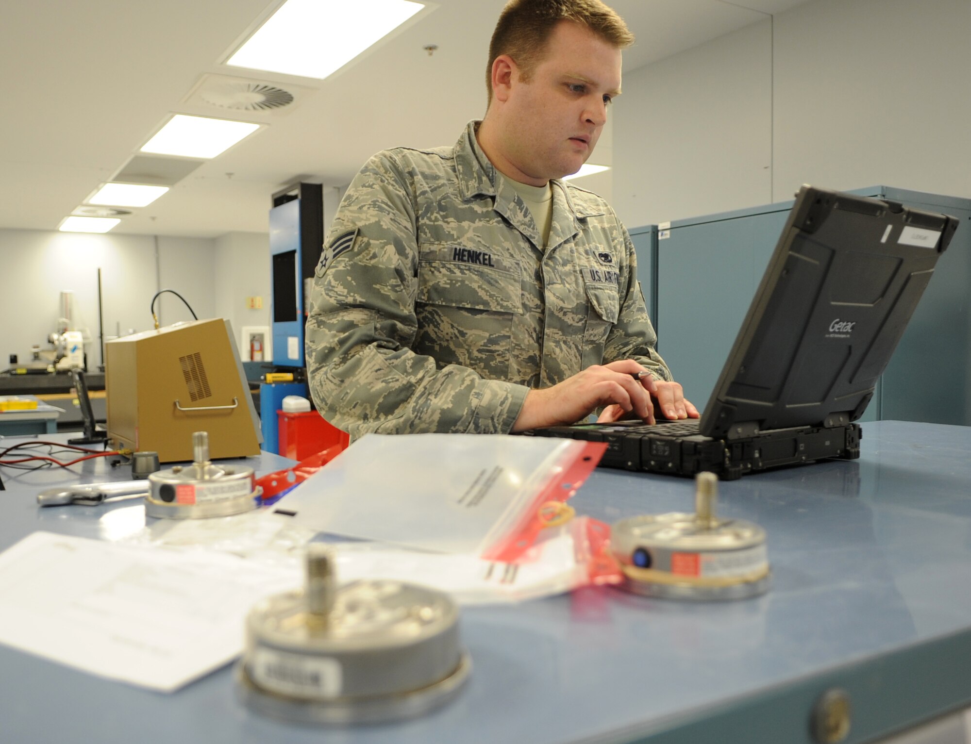 Senior Airman Phillip Henkel, a 19th Component Maintenance Squadron Precision Measurement Equipment Laboratory technician, checks the data from a vacuum gauge for a hydraulic system Aug. 8, 2013, at Little Rock Air Force Base, Ark. PMEL specializes in the calibration of many types of devices and equipment to help keep the base mission-ready. (U.S. Air Force photo by Staff Sgt. Caleb Pierce)