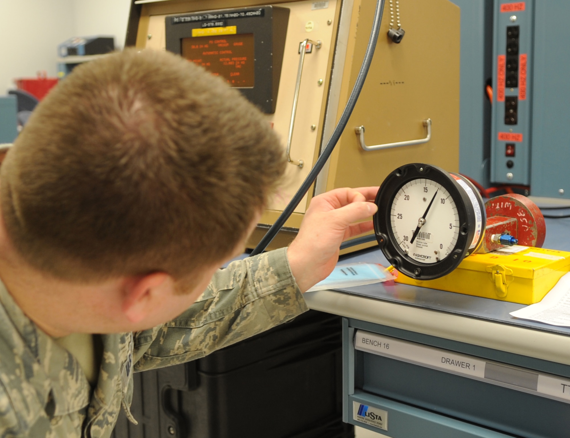 Senior Airman Phillip Henkel, a 19th Component Maintenance Squadron Precision Measurement Equipment Laboratory technician, calibrates a vacuum gauge for a hydralic system Aug. 8, 2013, at Little Rock Air Force Base, Ark. PMEL specializes in the calibration of many types of devices and equipment to help keep the base mission-ready. (U.S. Air Force photo by Staff Sgt. Caleb Pierce) 