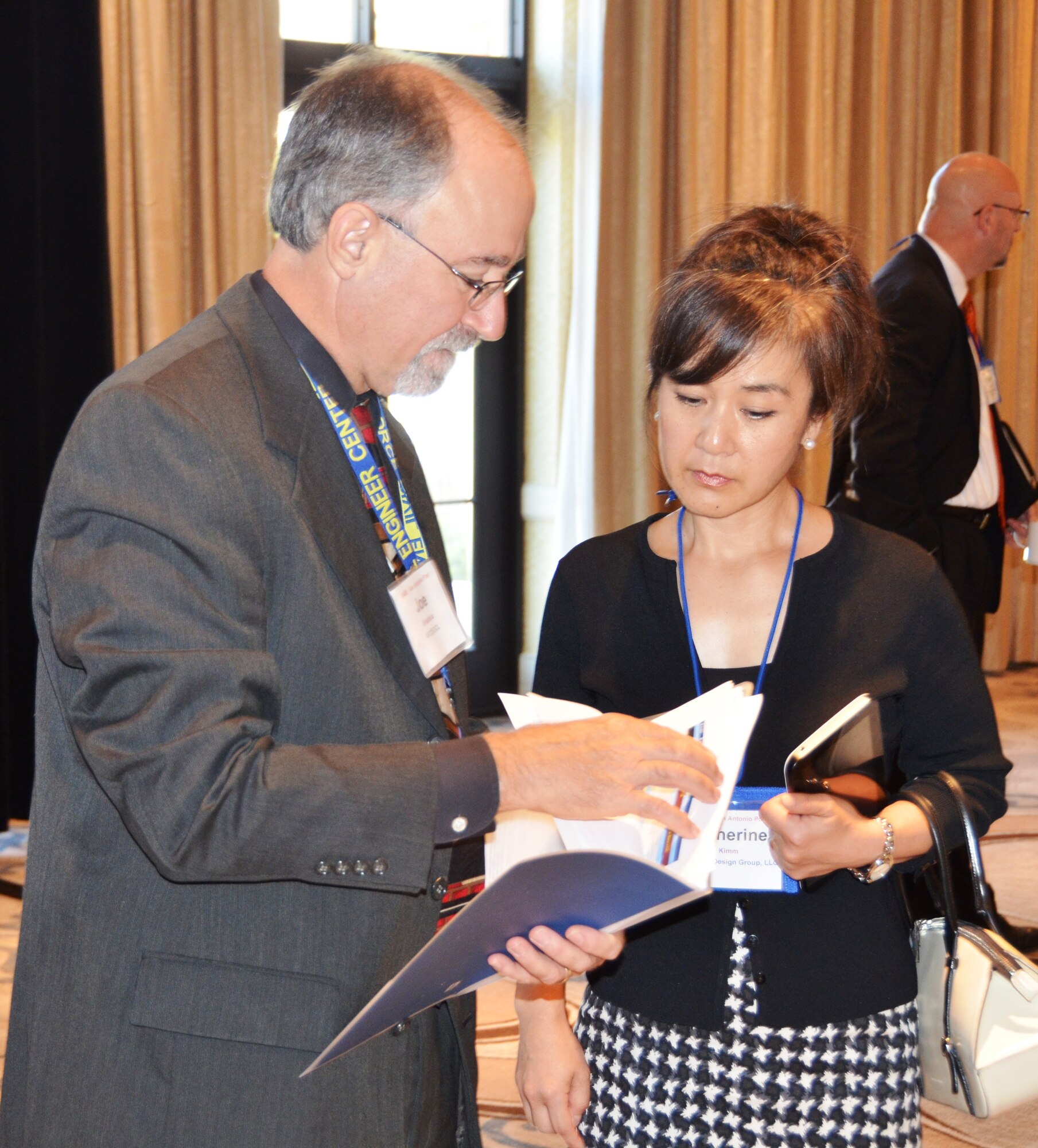 SAN ANTONIO -- Joe Sciabica, director of the Air Force Civil Engineer Center, discusses AFCEC operations with Katherine Kimm of WestEast Design Group at the Society of American Military Engineers Small Business Market Research Fair Aug. 20 at the Eilan Hotel & Spa in San Antonio. More than 250 industry representatives were on hand to learn about partnering opportunities with AFCEC and other agencies during the three-day event that concludes Aug. 22 with an AFCEC industry day. (U.S. Air Force Photo/Michael Briggs) 