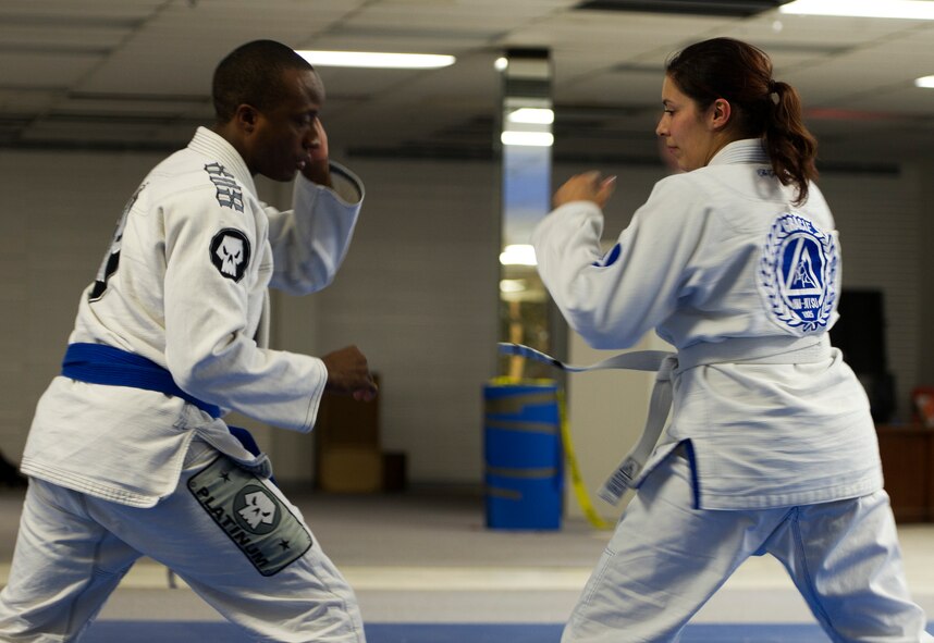Former 5th Bomb Wing Chief of Public Affairs, Capt. Genieve David, demonstrates Gracie Jiu Jitsu techniques during an instructor certification evaluation. To receive full instructor certification she must demonstrate 15 Gracie Jiu Jitsu techniques, with their variations, in fewer than 10 minutes and score 90 percent or more. The evaluation is conducted via a video evaluation process and uploaded to the Gracie Academy Web site where it is scored. If David succeeds, she will be awarded full instructor certification for the length of two years. David completed the Gracie Jiu Jitsu Women Empowered Probationary Instructor Certification Program in April. (U.S. Air Force photo/Airman 1st Class Kristoffer Kaubisch)