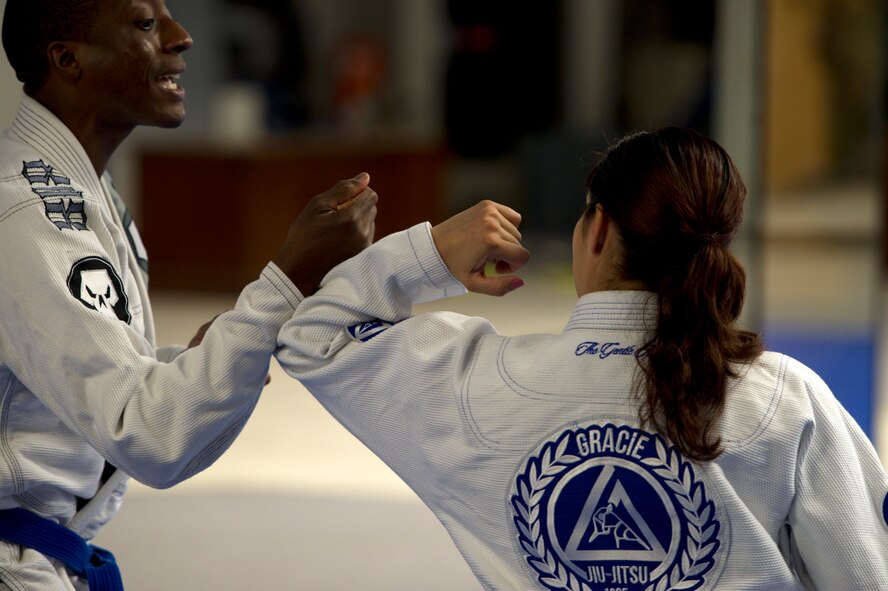 Former 5th Bomb Wing Chief of Public Affairs, Capt. Genieve David, demonstrates Gracie Jiu Jitsu techniques during an instructor certification evaluation. To receive full instructor certification she must demonstrate 15 Gracie Jiu Jitsu techniques, with their variations, in fewer than 10 minutes and score 90 percent or more. The evaluation is conducted via a video evaluation process and uploaded to the Gracie Academy Web site where it is scored. If David succeeds, she will be awarded full instructor certification for the length of two years. David completed the Gracie Jiu Jitsu Women Empowered Probationary Instructor Certification Program in April. (U.S. Air Force photo/Airman 1st Class Kristoffer Kaubisch)