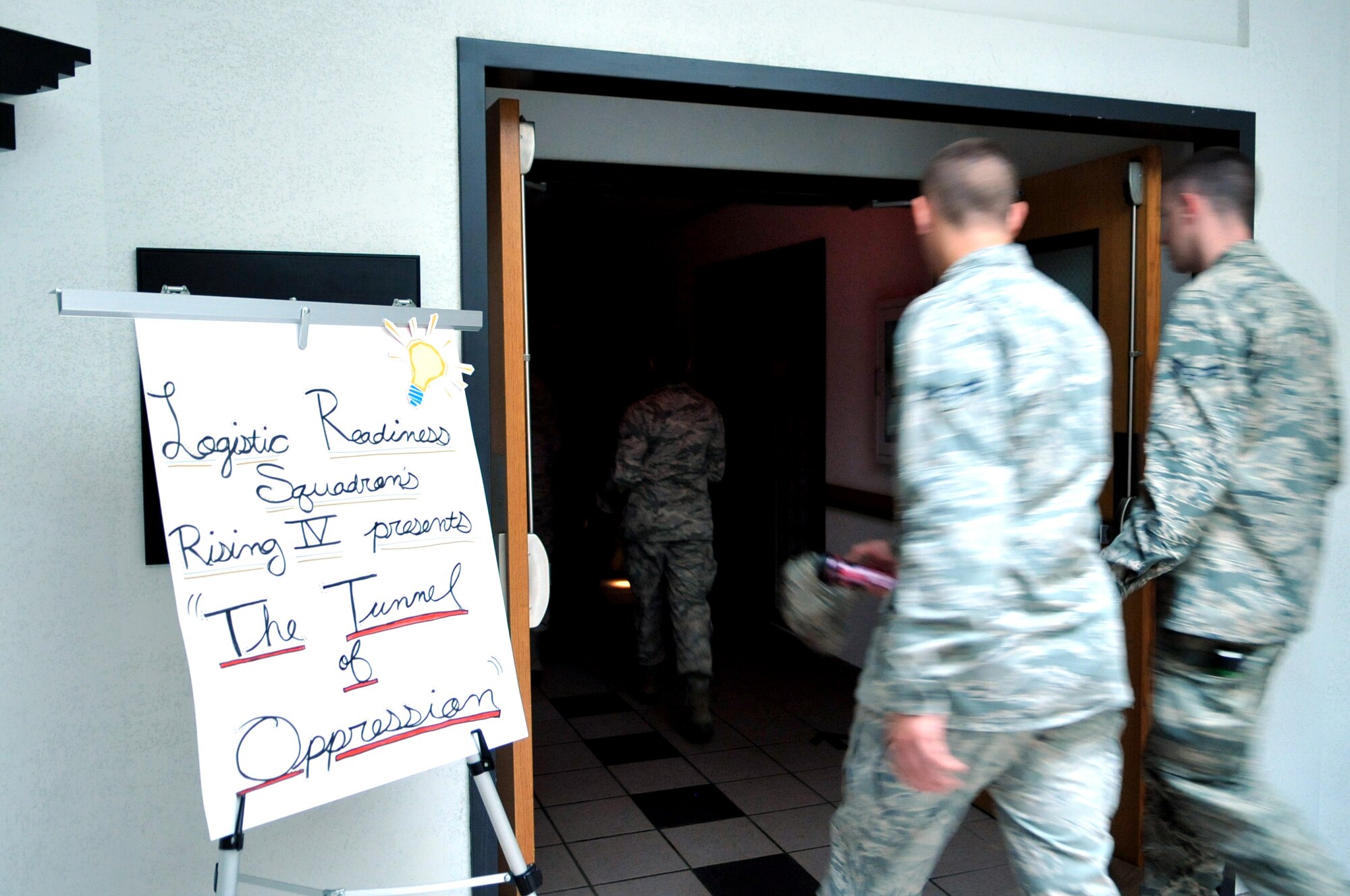 Airmen from Grand Forks Air Force Base participate in the Tunnel of Oppression sponsored by the 319th Logistics Readiness Squadron Rising IV committee, Aug. 20, 2013. The Tunnel of Oppression was used to raise awareness on subjects such as drug and alcohol abuse, domestic violence, divorce, suicide, and depression. (U.S. Air Force photo/Staff Sgt. Amanda N. Grabiec)