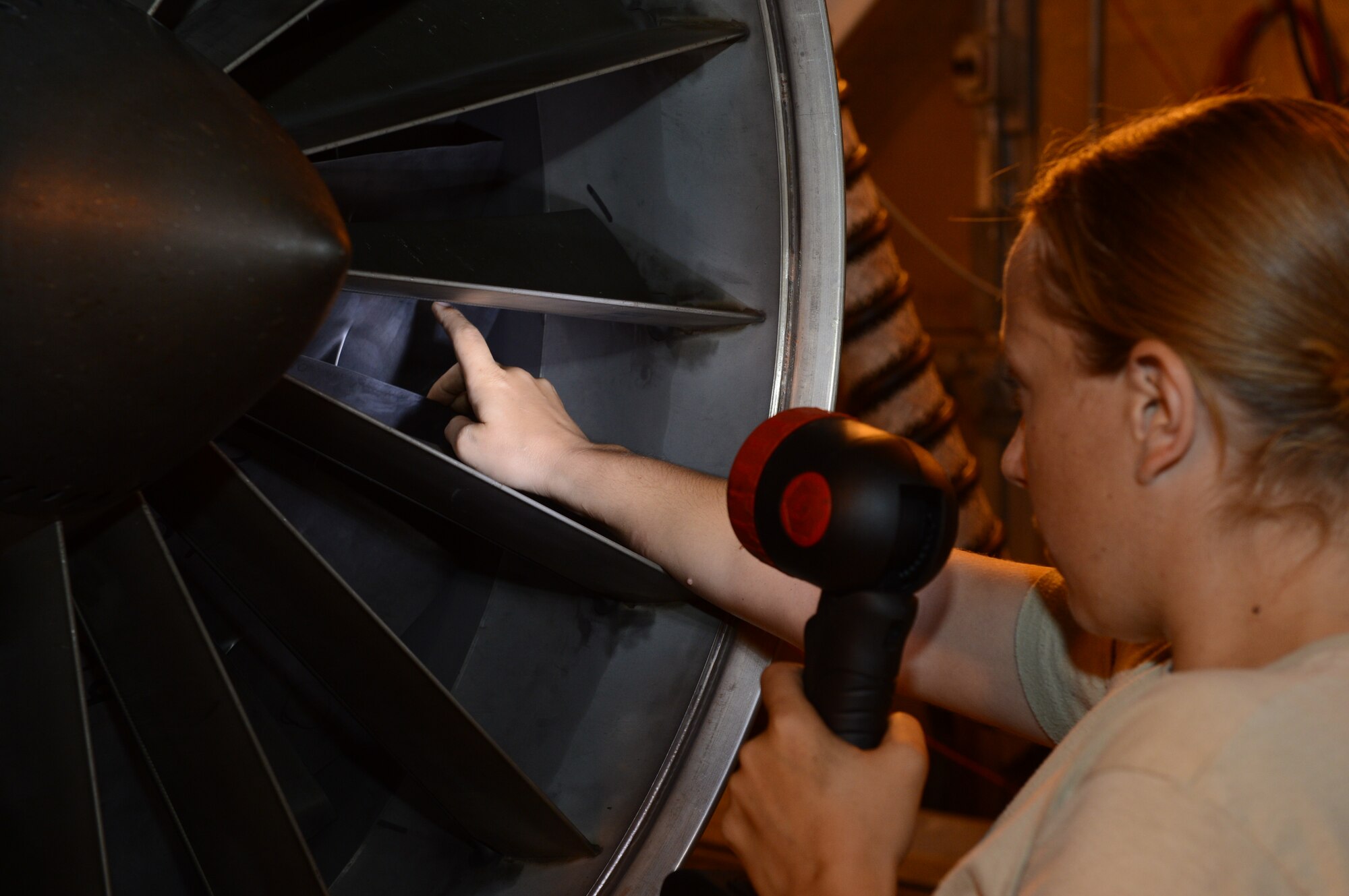SPANGDAHLEM AIR BASE, Germany – U.S. Air Force Staff Sgt. Kelly Miller, 52nd Component Maintenance Squadron aerospace propulsion technician from Quakertown Pa., performs an intake and exhaust inspection on an F110-100 engine after a test run Aug. 8, 2013. During this inspection Miller looks for any foreign object damage or unserviceable parts. (U.S. Air Force photo by Airman 1st Class Kyle Gese/Released)