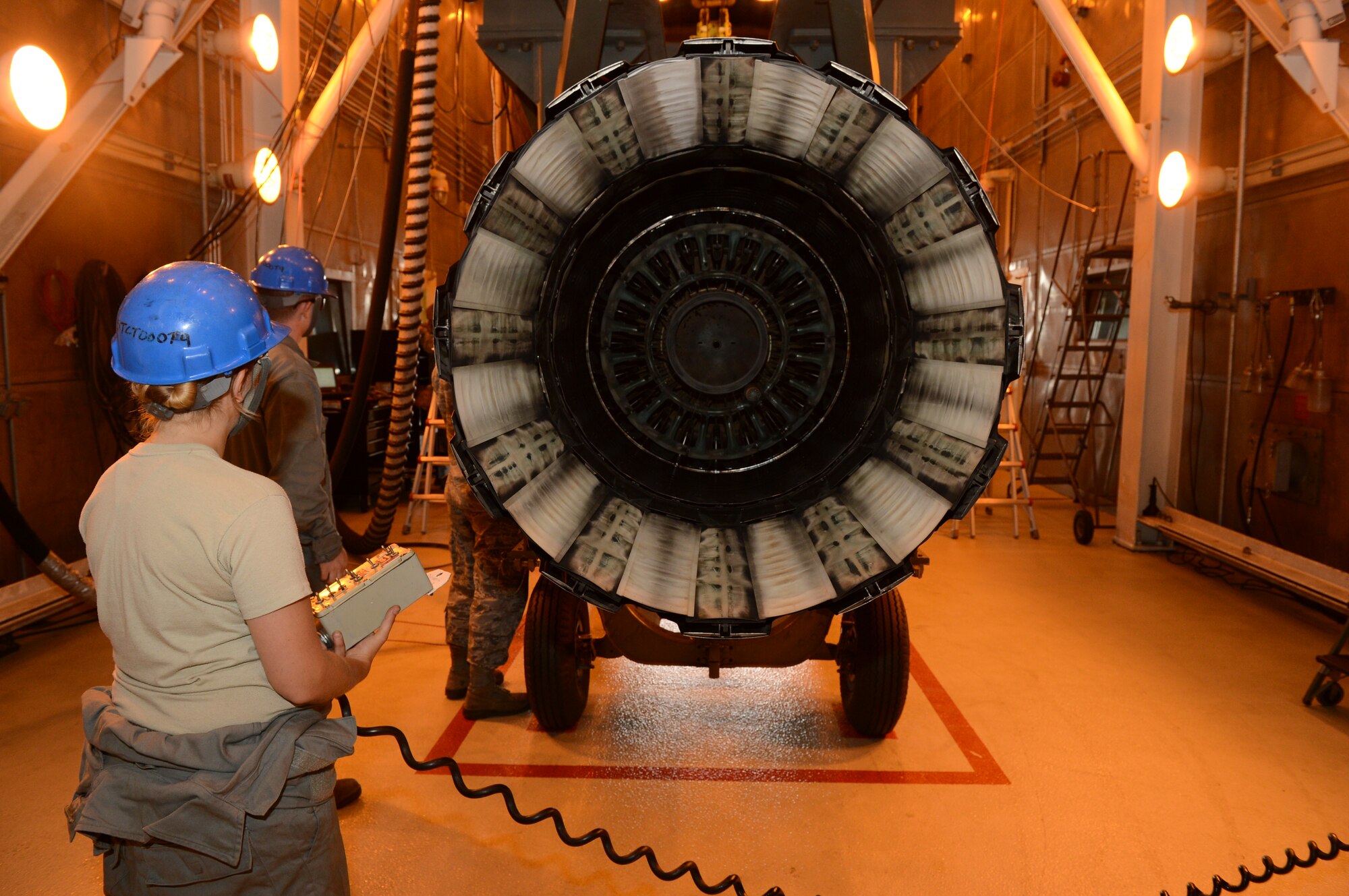 SPANGDAHLEM AIR BASE, Germany – U.S. Air Force Staff Sgt. Kelly Miller, 52nd Component Maintenance Squadron aerospace propulsion craftsman from Quakertown Pa., lowers a F110-100 engine onto an engine 3000 transportation trailer Aug. 8, 2013. After an engine is inspected at the test cell shop, it is then sent back to the main propulsion flight for a final quality check. (U.S. Air Force photo by Airman 1st Class Kyle Gese/Released)