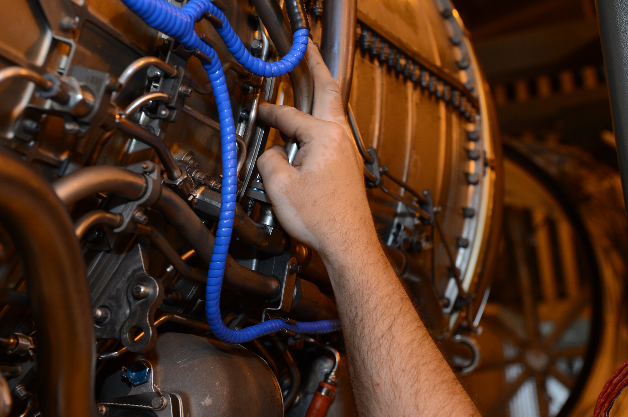 SPANGDAHLEM AIR BASE, Germany – U.S. Air Force Staff Sgt. Douglas Melton, 52nd Component Maintenance Squadron aerospace propulsion craftsman from Altus Okla., tightens a bolt on an F110-100 engine Aug. 8, 2013. Testing every part of the engine is crucial to keeping aircraft fully mission capable. Spangdahlem also tests engines from Aviano Air Base, Italy. (U.S. Air Force photo by Airman 1st. Class Kyle Gese/Released)