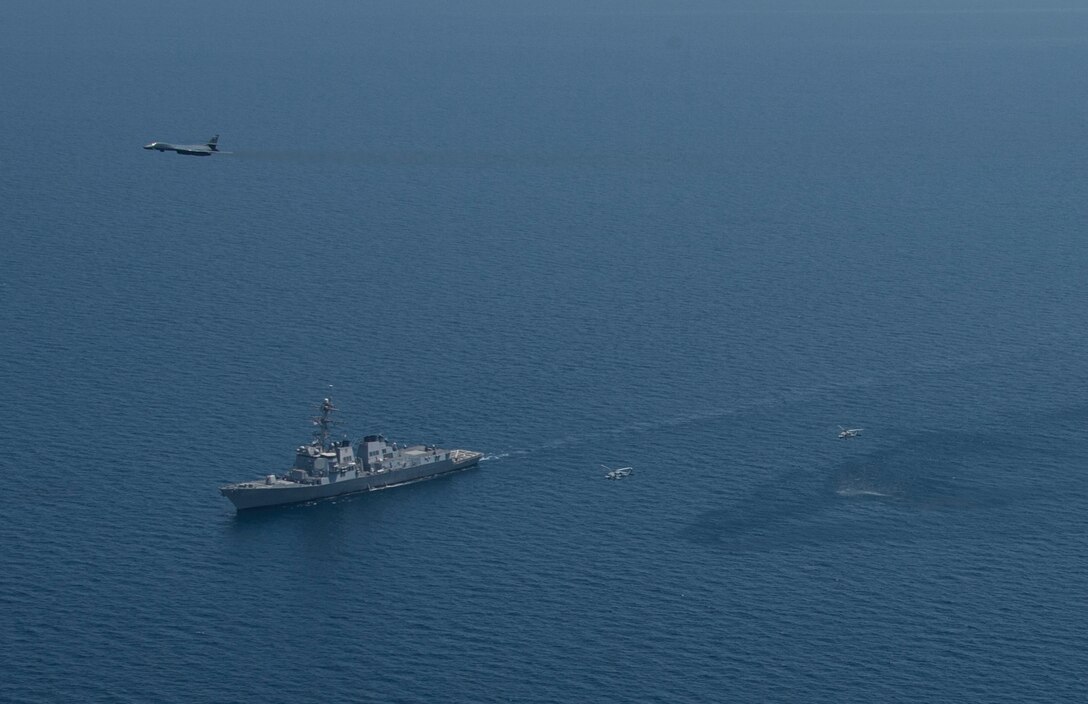 A 9th Expeditionary Bomb Squadron B-1B Lancer from the 379th Air Expeditionary Wing flies by U.S. Navy ships participating in exercise Spartan Kopis over the Arabian Gulf, Aug. 13, 2013. Spartan Kopis is a U.S. 5th Fleet training event that validates the effectiveness of using joint aviation assets in a maritime environment, as well as exercising joint force command and control structure and communications. (U.S. Navy photo/Mass Communication Specialist 1st Class Daniel Gay)