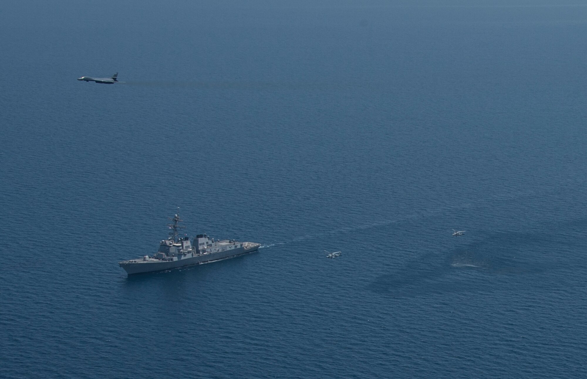 A 9th Expeditionary Bomb Squadron B-1B Lancer from the 379th Air Expeditionary Wing flies by U.S. Navy ships participating in exercise Spartan Kopis over the Arabian Gulf, Aug. 13, 2013. Spartan Kopis is a U.S. 5th Fleet training event that validates the effectiveness of using joint aviation assets in a maritime environment, as well as exercising joint force command and control structure and communications. (U.S. Navy photo/Mass Communication Specialist 1st Class Daniel Gay)