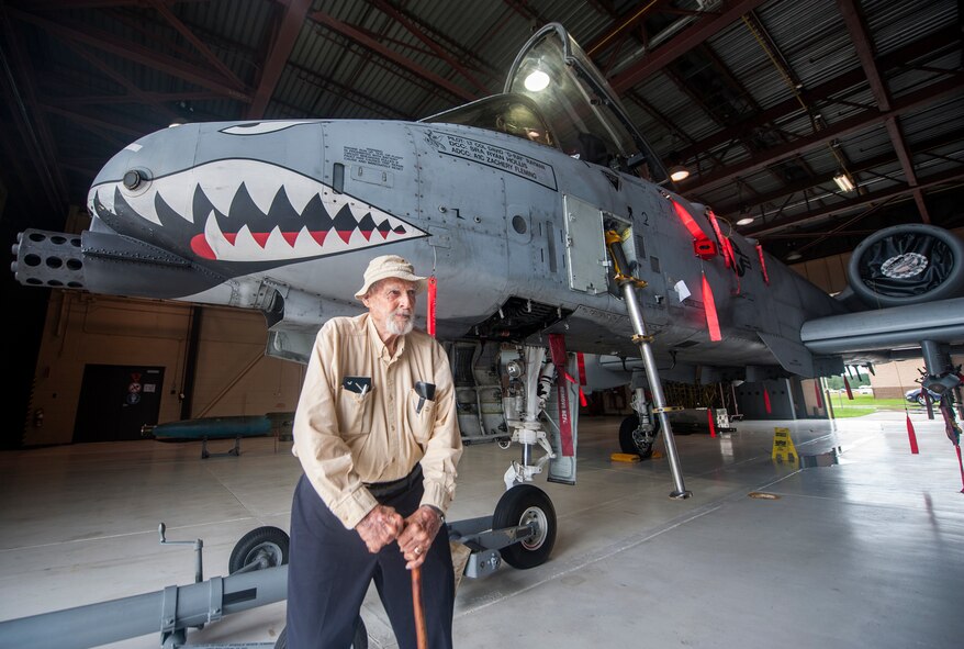 Retired Lt. Col. Harold Stuart, a former 76th Fighter Squadron P-40 Warhawk pilot, stands in front of an A-10C Thunderbolt II at Moody Air Force Base, Ga., July 22, 2013. The 1st American Volunteer Group, which was known as the Flying Tigers and later became the 23d Fighter Group, started the shark-tooth nose art. (U.S. Air Force photo by Senior Airman Jarrod Grammel/Released)

