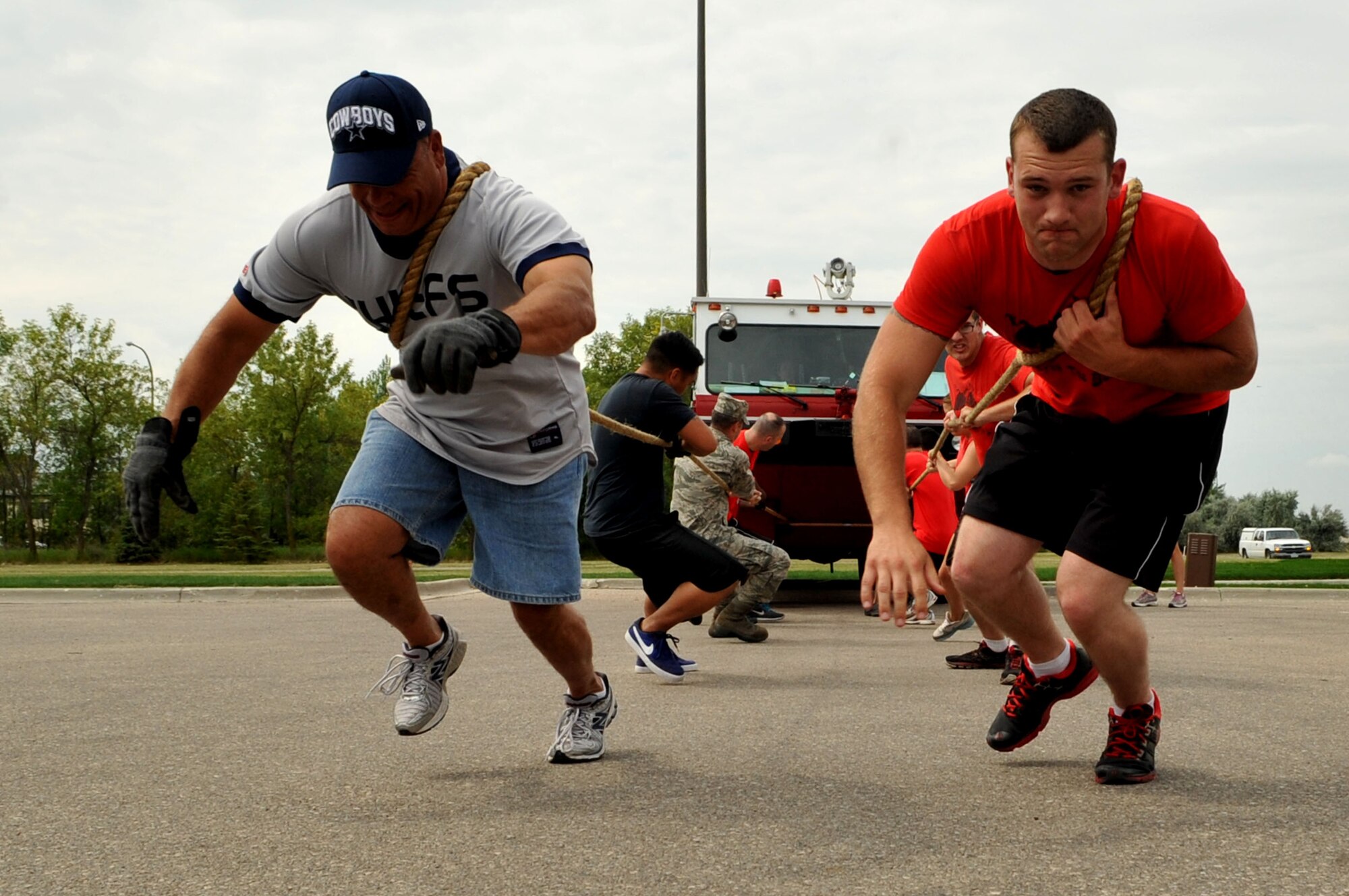 Members from the 319th Civil Engineering Squadron compete in the fire truck-pull during the 2013 Summer Bash Aug. 15, 2013, on Grand Forks Air Force Base, N.D. Summer Bash is an annual event designed to boost morale and increase esprit de corps.  (U.S. Air Force photo/Staff Sgt. Amanda N. Grabiec)
