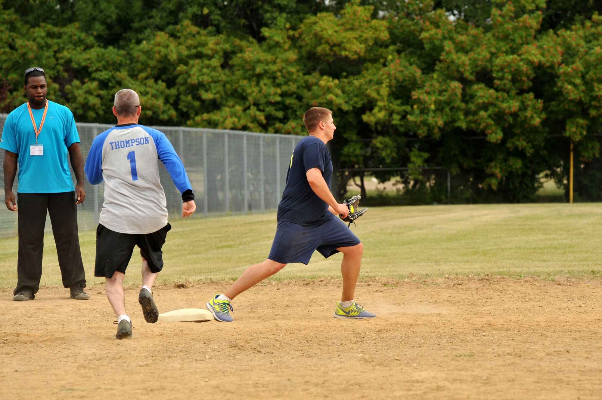 Staff Sgt. Shane Holland, 319th Wing Staff Agencies, steps on third base for an out while playing backwards softball during the 2013 Summer Bash Aug. 15, 2013, on Grand Forks Air Force Base, N.D. Summer Bash is an annual event designed to boost morale and increase esprit de corps. (U.S. Air Force photo/Staff Sgt. Amanda N. Grabiec)