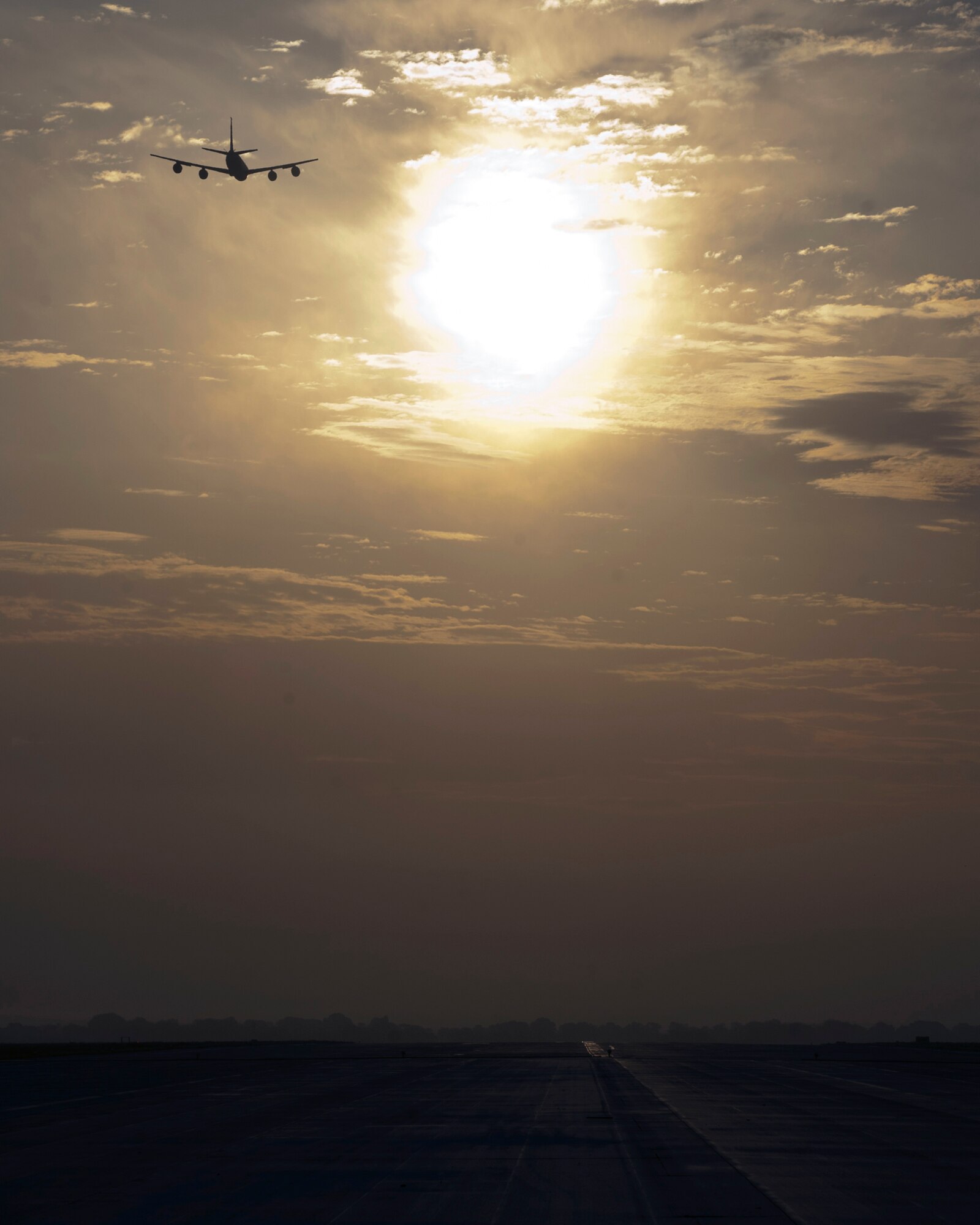 A KC-135 Stratotanker flies into the dawn over Transit Center at Manas, Kyrgyzstan, August 22, 2013. The KC-135 transfers enough fuel through the refueling boom in one minute to operate the average family car for more than one year. (U.S. Air Force photo/Staff Sgt. Robert Barnett)