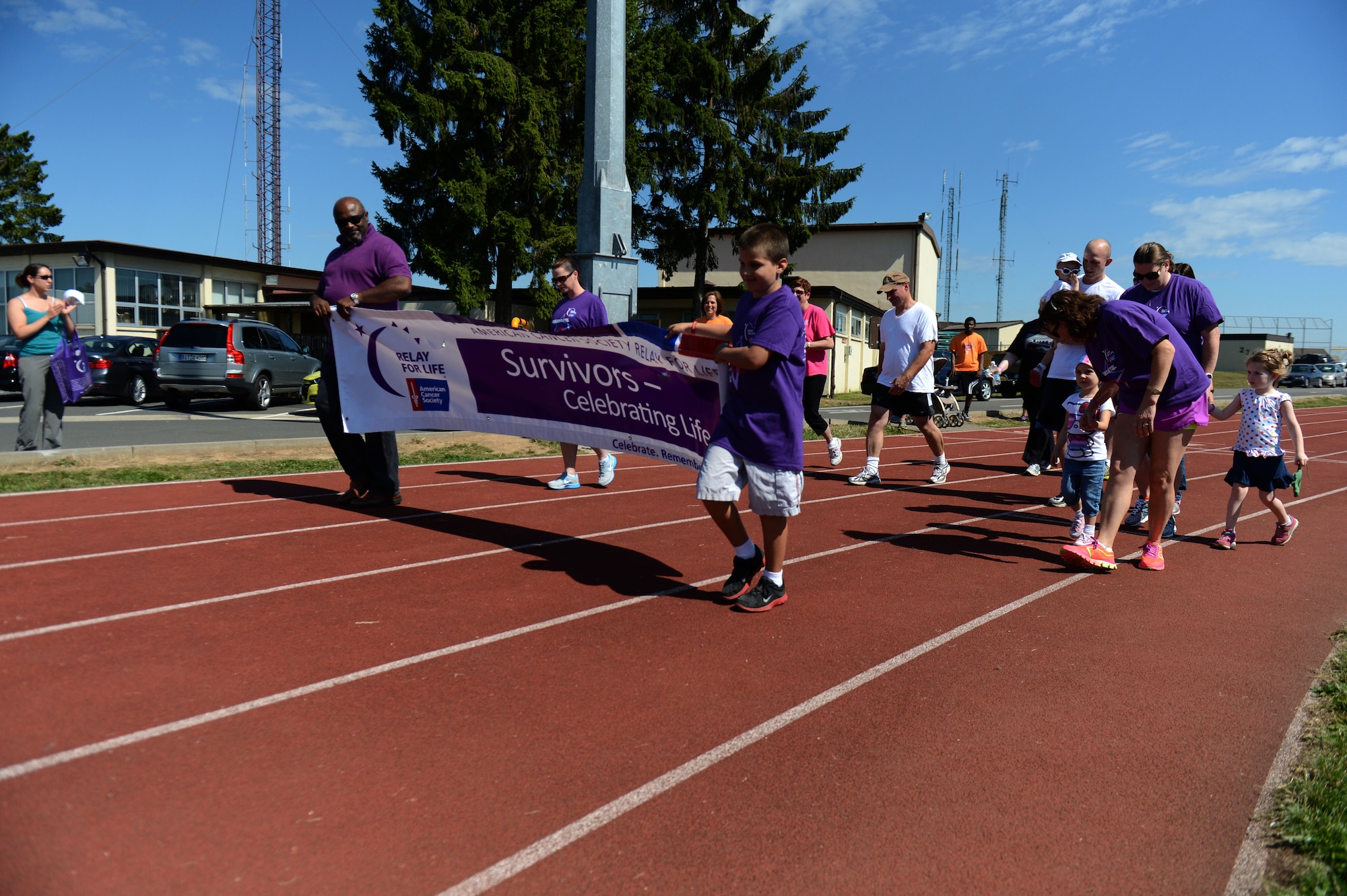 SPANGDAHLEM AIR BASE, Germany – Cancer survivors participate in the Survivor lap portion of a Relay for Life event at the track near the Skelton Memorial Fitness Center Aug. 16, 2013. The survivor lap symbolized the beginning of the event, which raised more than $24,700 toward cancer research. (U.S. Air Force photo by Airman 1st Class Gustavo Castillo/Released)