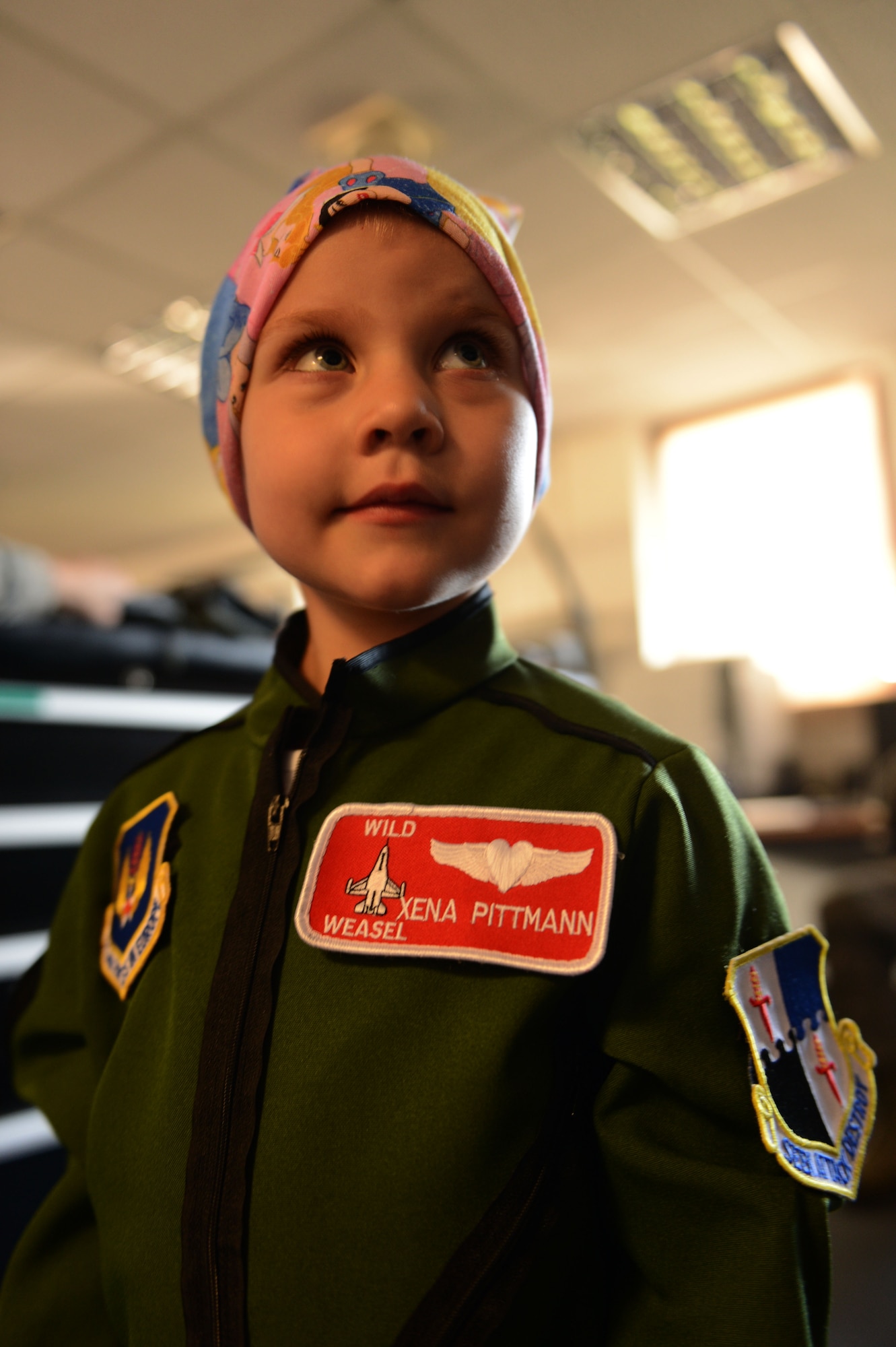 SPANGDAHLEM AIR BASE, Germany – Sarah Pittman, 4, poses for a photo at the 480th Fighter Squadron Aug. 16, 2013. Sarah and another child recovering from leukemia toured the 480th FS and were given flightsuits with callsigns before viewing an F-16 Fighting Falcon fighter aircraft. (U.S. Air Force photo by Airman 1st Class Gustavo Castillo/Released)