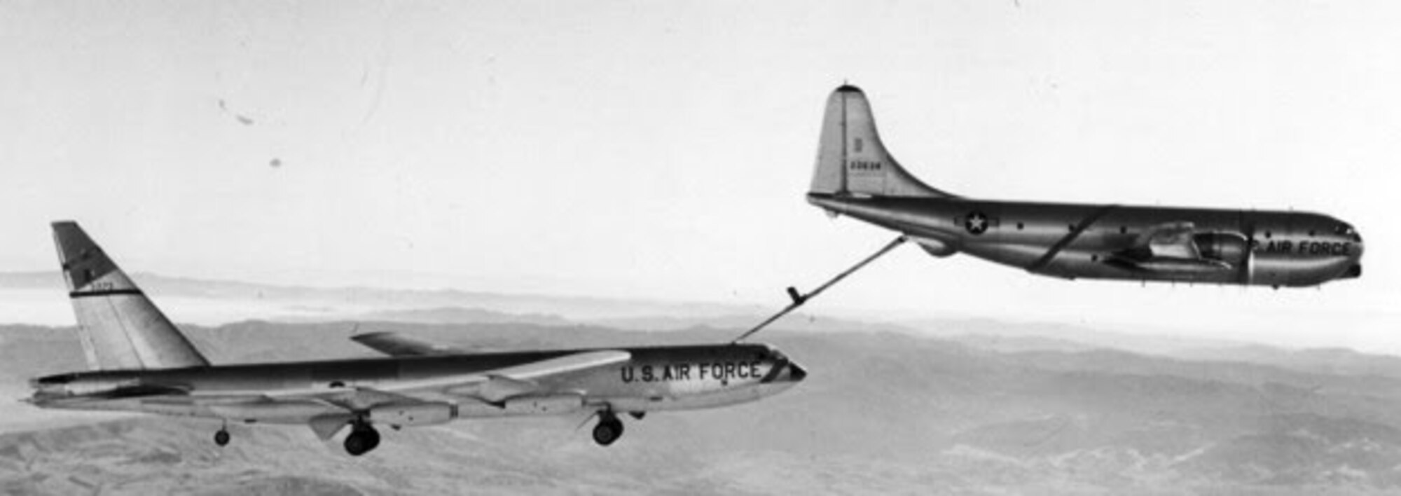 A B-52 Stratofortress and a KC-97 Stratotanker take a slow dive during an aerial refueling in the 1950s. The B-52 had to slow down, drop its flaps and tires in order for the KC-97 to keep up with its speed and altitude. (Courtesy photo)