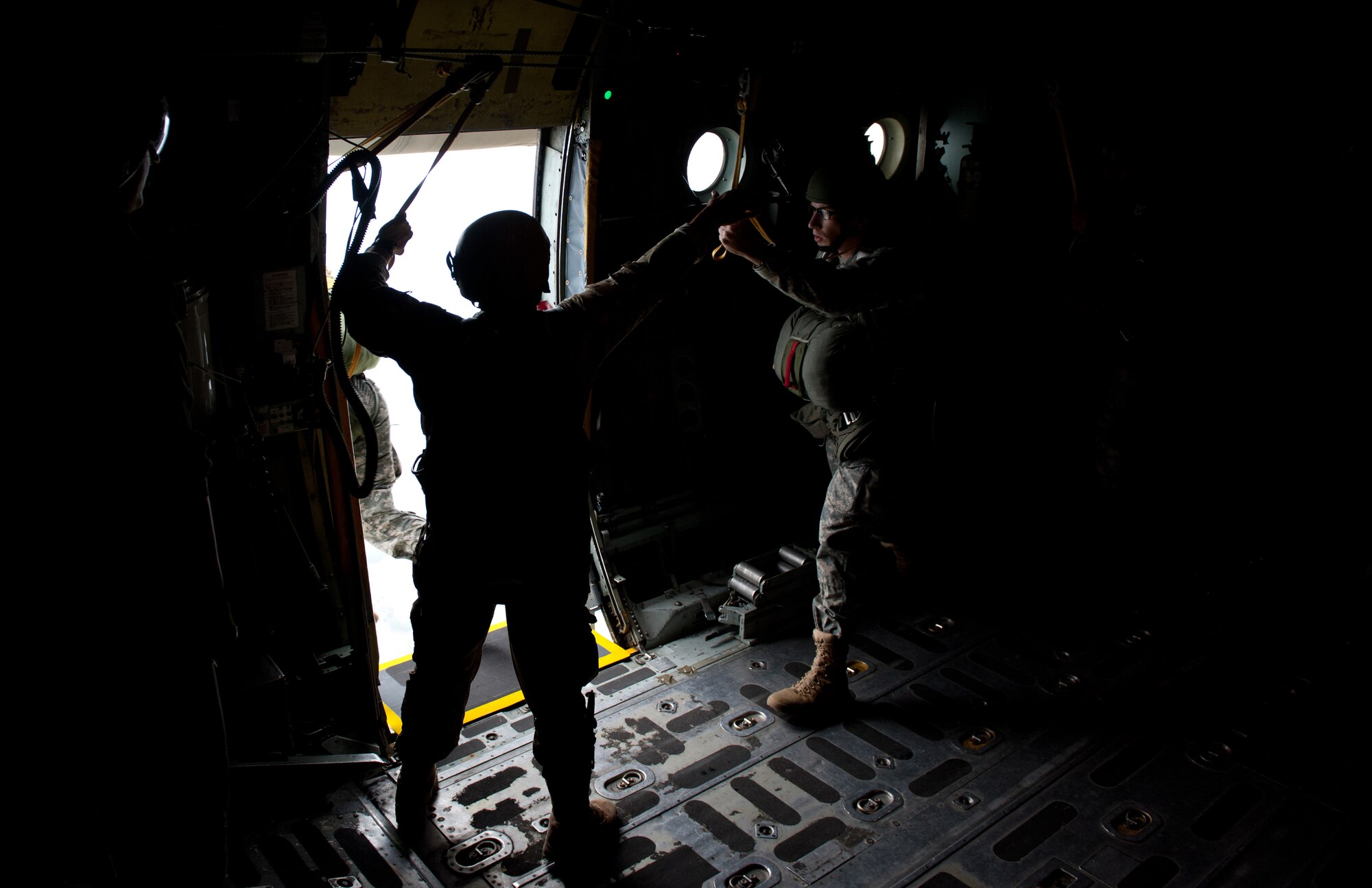 U.S. Army Soldiers jump out of a C-130 Hercules Aug. 22, 2013, during jump training over Yokota Air Base, Japan. The Soldiers are assigned to the 1st Battalion, 1st Special Forces Group. (U.S. Air Force photo by Senior Airman Cody H. Ramirez)
